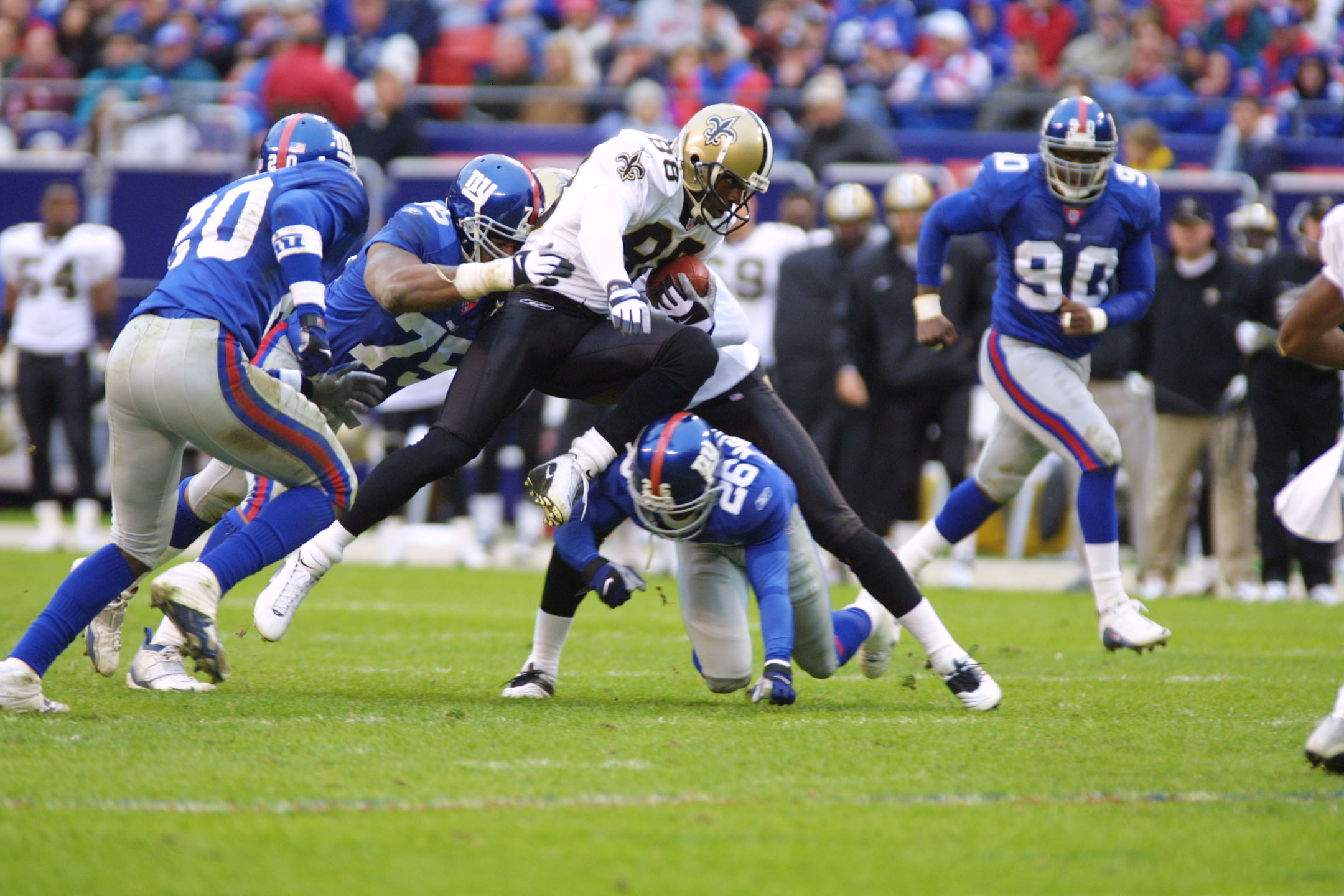 30 Sep 2001:  Willie Jackson #88 of the New Orleans Saints is tackled by Keith Hamilton #75 and Emmanuel McDaniel #26 of the New York Giants during the game at Giants Stadium in East Rutherford, New Jersey. The New York Giants win, 21-13 over the New Orle