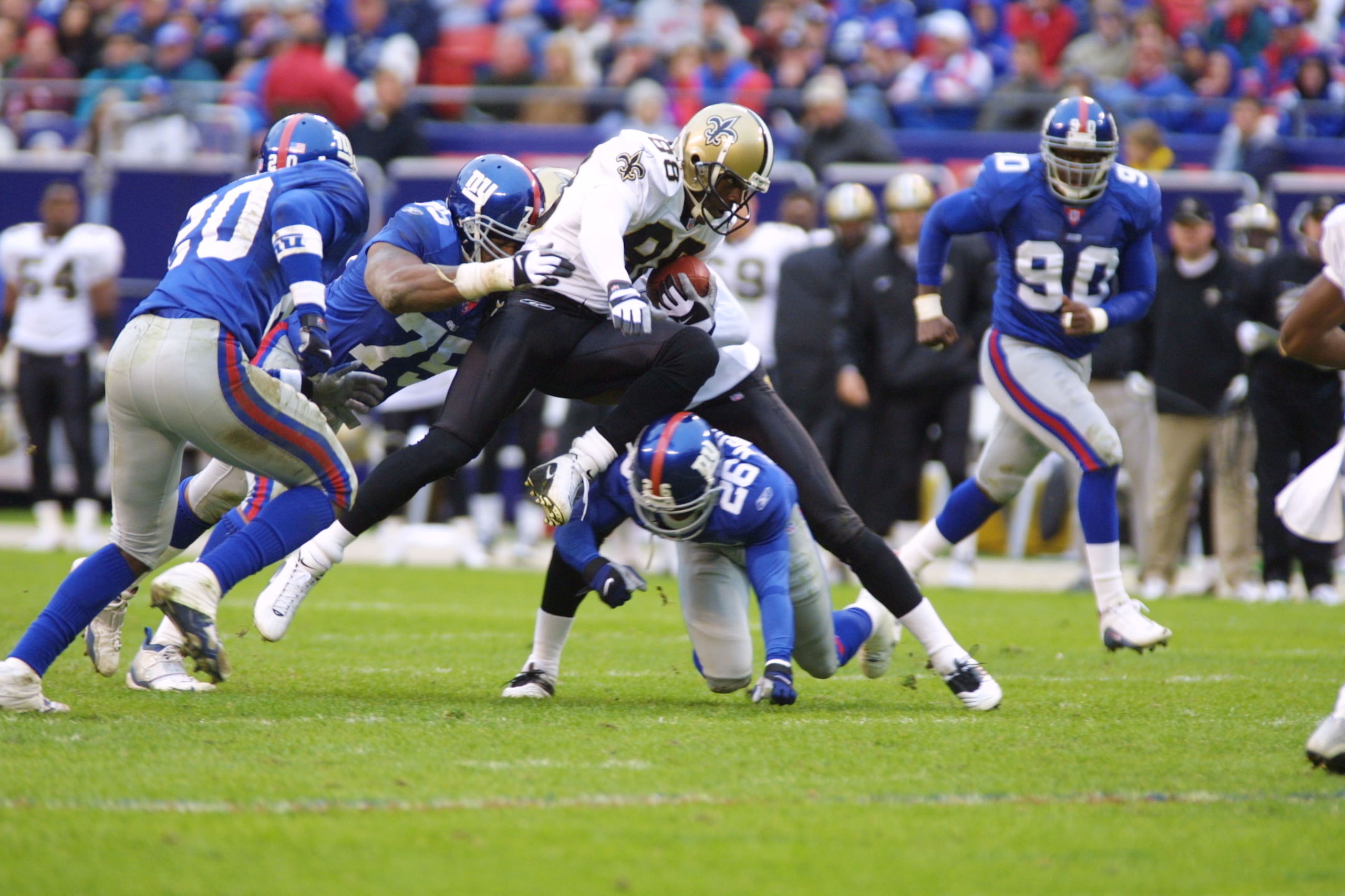 30 Sep 2001: Willie Jackson #88 of the New Orleans Saints is tackled by Keith Hamilton #75 and Emmanuel McDaniel #26 of the New York Giants during the game at Giants Stadium in East Rutherford, New Jersey. The New York Giants win, 21-13 over the New Orle 30 Sep 2001: Willie Jackson #88 of the New Orleans Saints is tackled by Keith Hamilton #75 and Emmanuel McDaniel #26 of the New York Giants during the game at Giants Stadium in East Rutherford, New Jersey. The New York Giants win, 21-13 over the New Orle