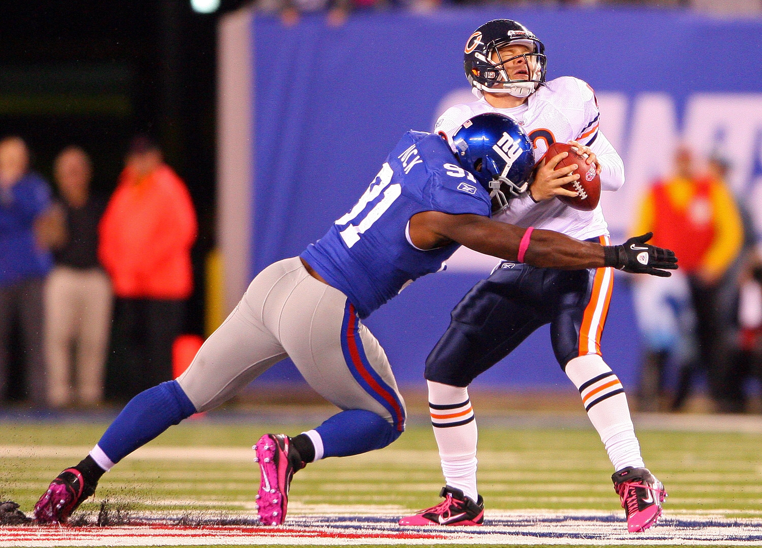 EAST RUTHERFORD, NJ - OCTOBER 03:  Justin Tuck #91 of the New York Giants sacks against Caleb Hanie #12 of the Chicago Bear at New Meadowlands Stadium on October 3, 2010 in East Rutherford, New Jersey.  (Photo by Andrew Burton/Getty Images)