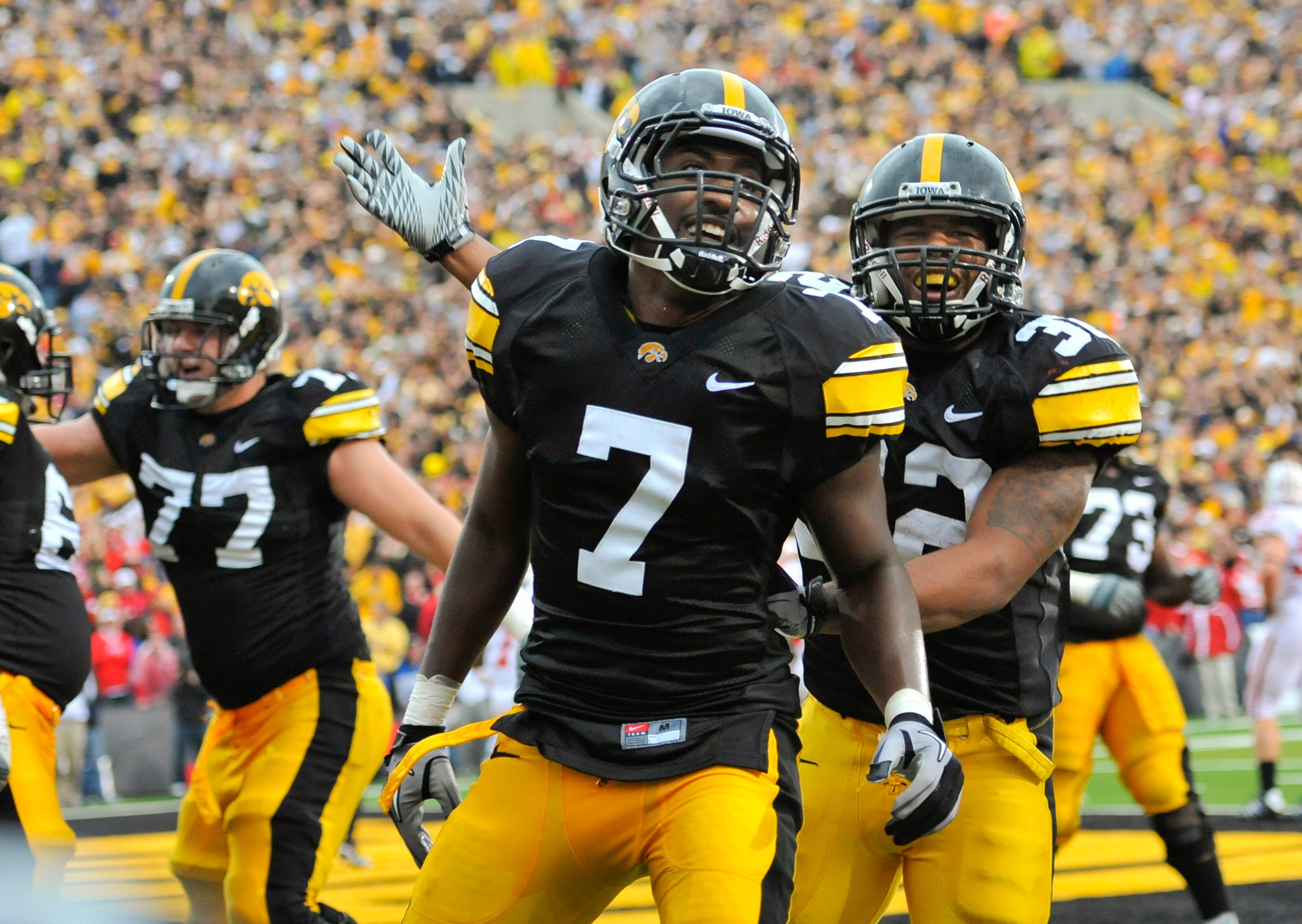 IOWA CITY, IA - OCTOBER 23- Wide receiver Marvin McNutt Jr. #7 of the University of Iowa Hawkeyes celebrates with teammate running back Adam Robinson #32 after scoring a touchdown against the Wisconsin Badgers during the second half of play at Kinnick Sta