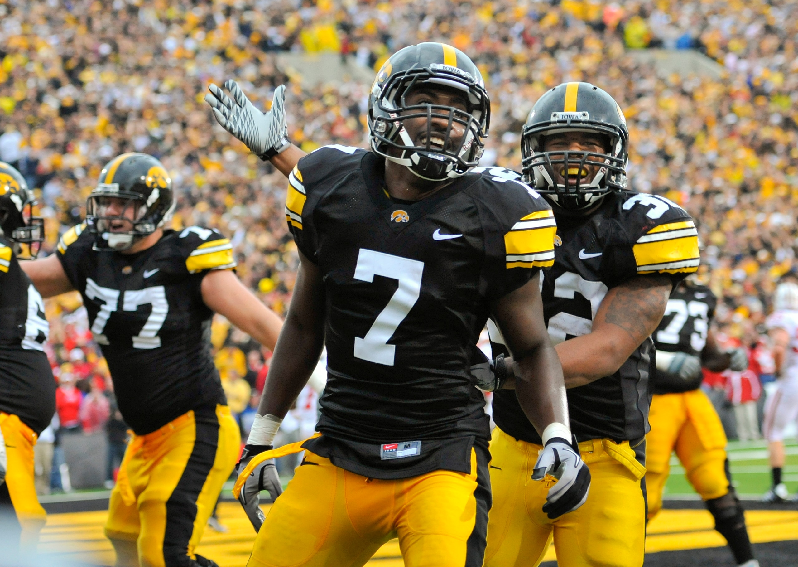IOWA CITY, IA - OCTOBER 23- Wide receiver Marvin McNutt Jr. #7 of the University of Iowa Hawkeyes celebrates with teammate running back Adam Robinson #32 after scoring a touchdown against the Wisconsin Badgers during the second half of play at Kinnick Sta