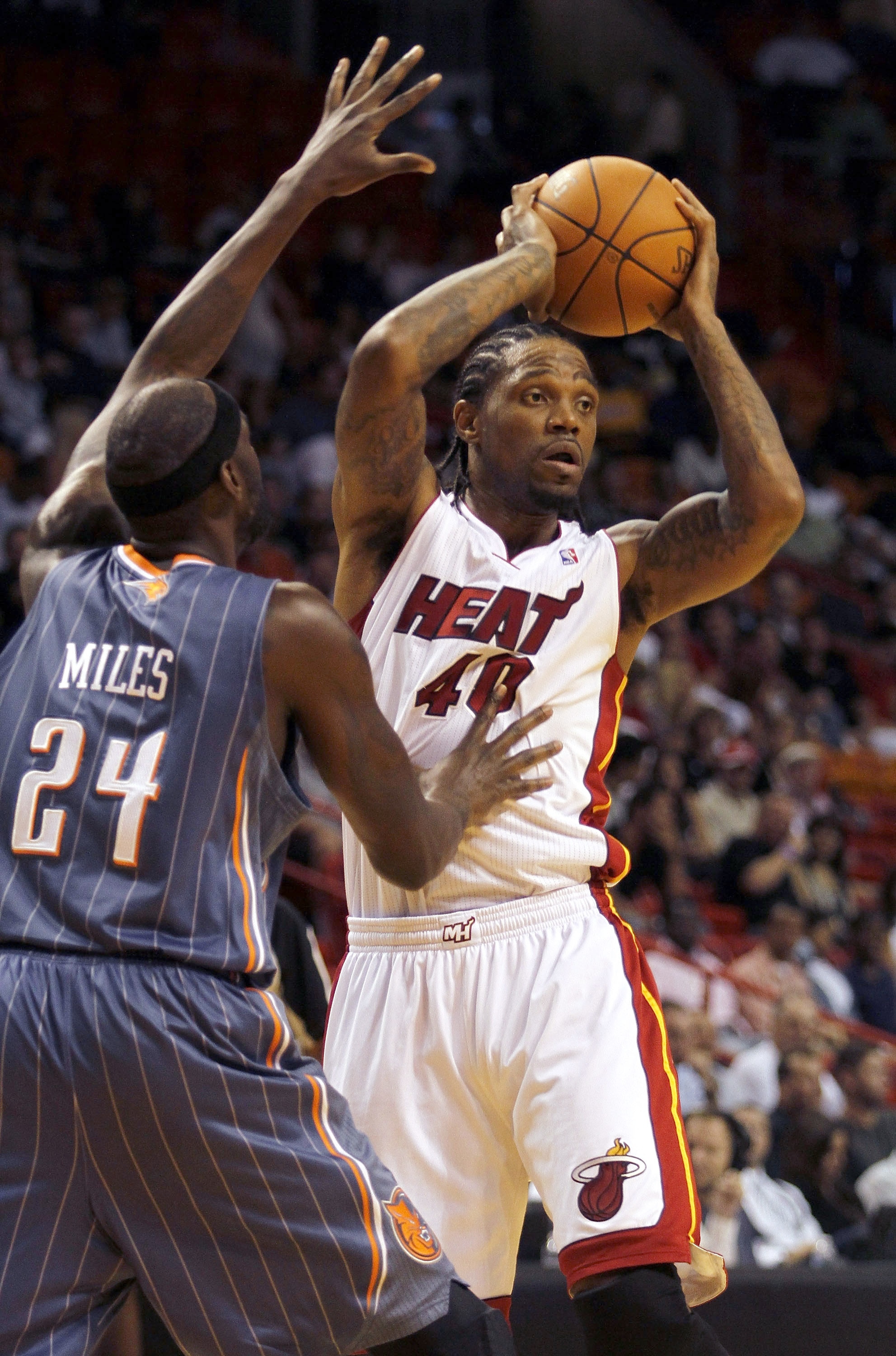 MIAMI - OCTOBER 18:  Forward Udonis Haslam #40 of the Miami Heat looks to pass against Forward Darius Miles #24 of the Charlotte Bobcats on October 18, 2010 at American Airlines Arena in Miami, Florida. NOTE TO USER: User expressly acknowledges and agrees