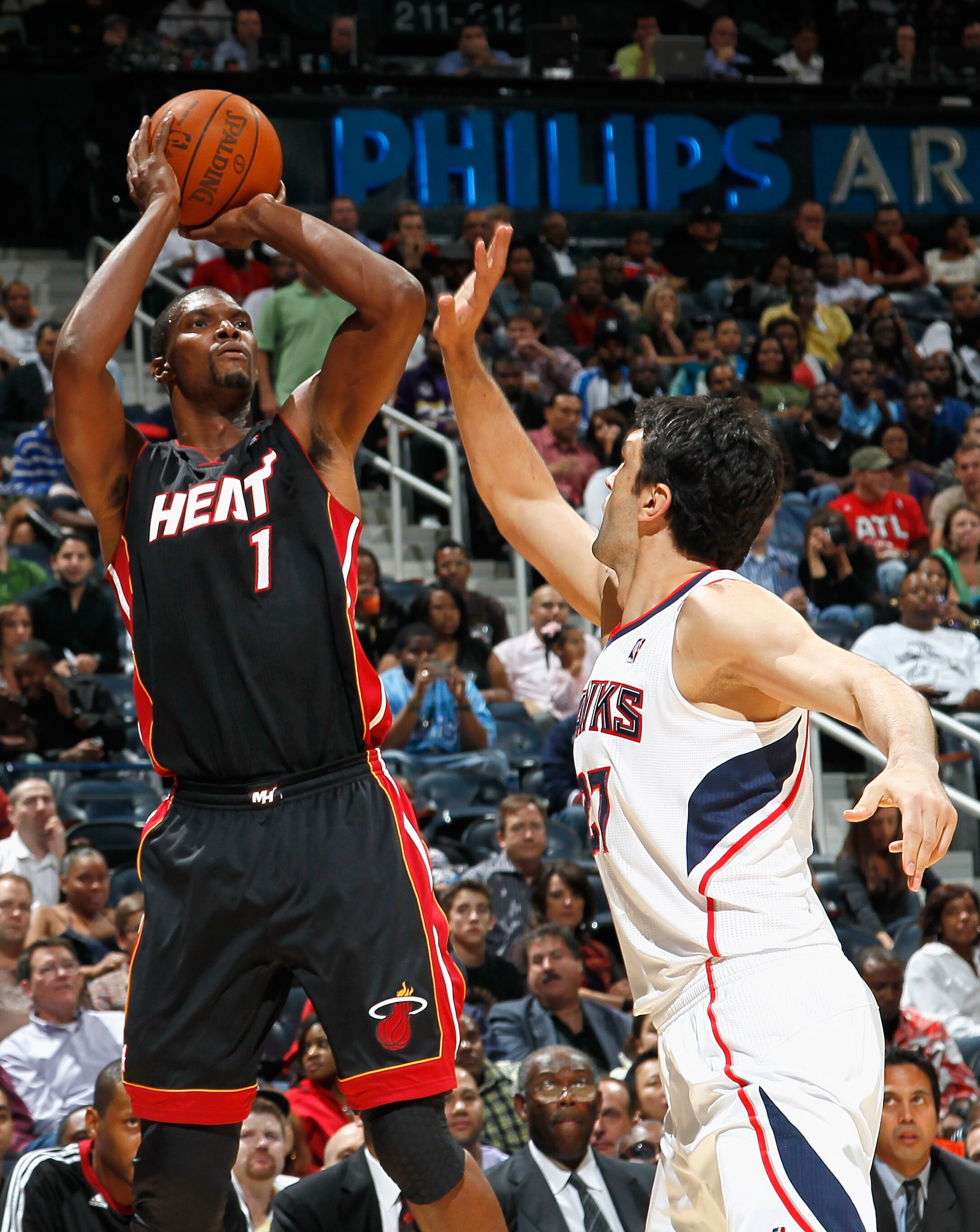 ATLANTA - OCTOBER 21:  Chris Bosh #1 of the Miami Heat shoots over Zaza Pachulia #27 of the Atlanta Hawks at Philips Arena on October 21, 2010 in Atlanta, Georgia.  (Photo by Kevin C. Cox/Getty Images)