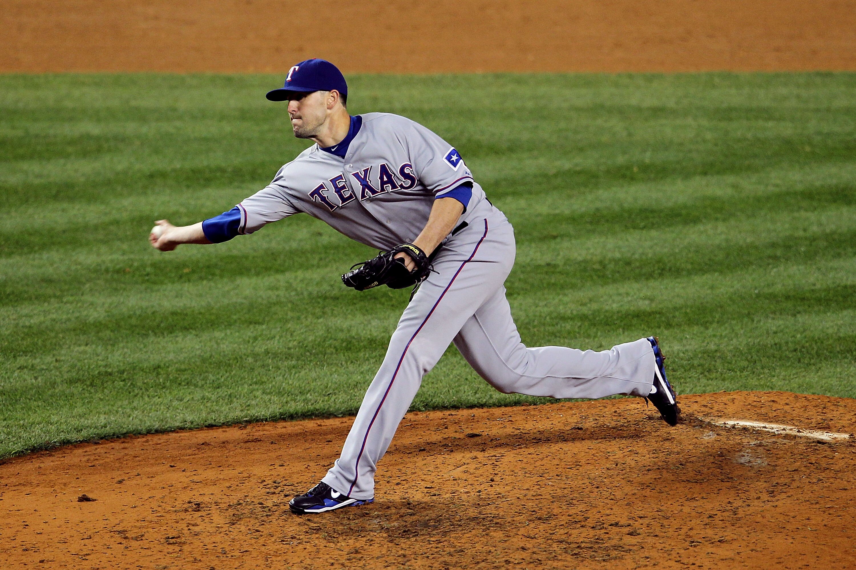 NEW YORK - OCTOBER 19:  Darren O'Day #56 of  the Texas Rangers pitches against the New York Yankees  in Game Four of the ALCS during the 2010 MLB Playoffs at Yankee Stadium on October 19, 2010 in the Bronx borough of New York City.  (Photo by Nick Laham/G
