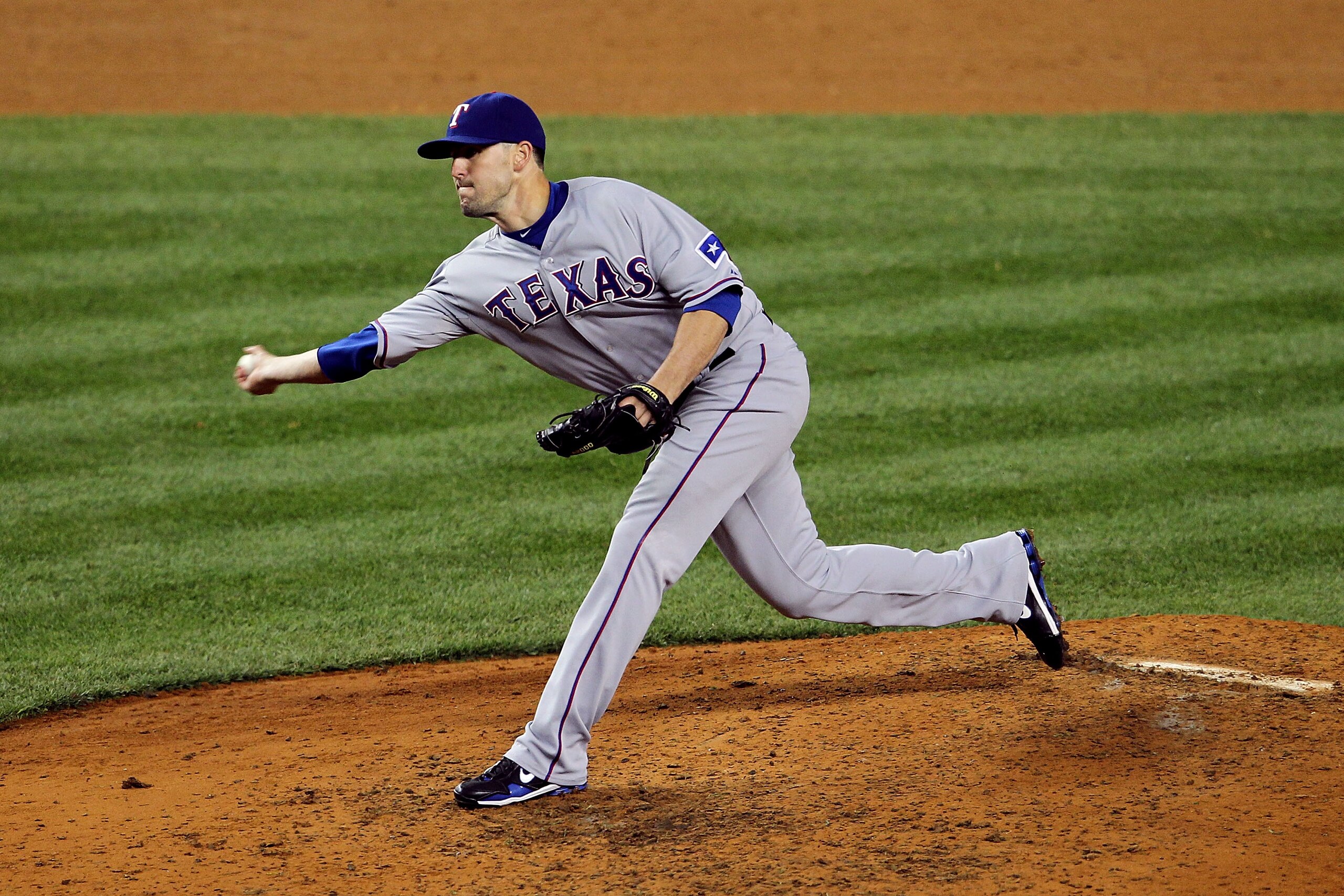 NEW YORK - OCTOBER 19:  Darren O'Day #56 of  the Texas Rangers pitches against the New York Yankees  in Game Four of the ALCS during the 2010 MLB Playoffs at Yankee Stadium on October 19, 2010 in the Bronx borough of New York City.  (Photo by Nick Laham/G