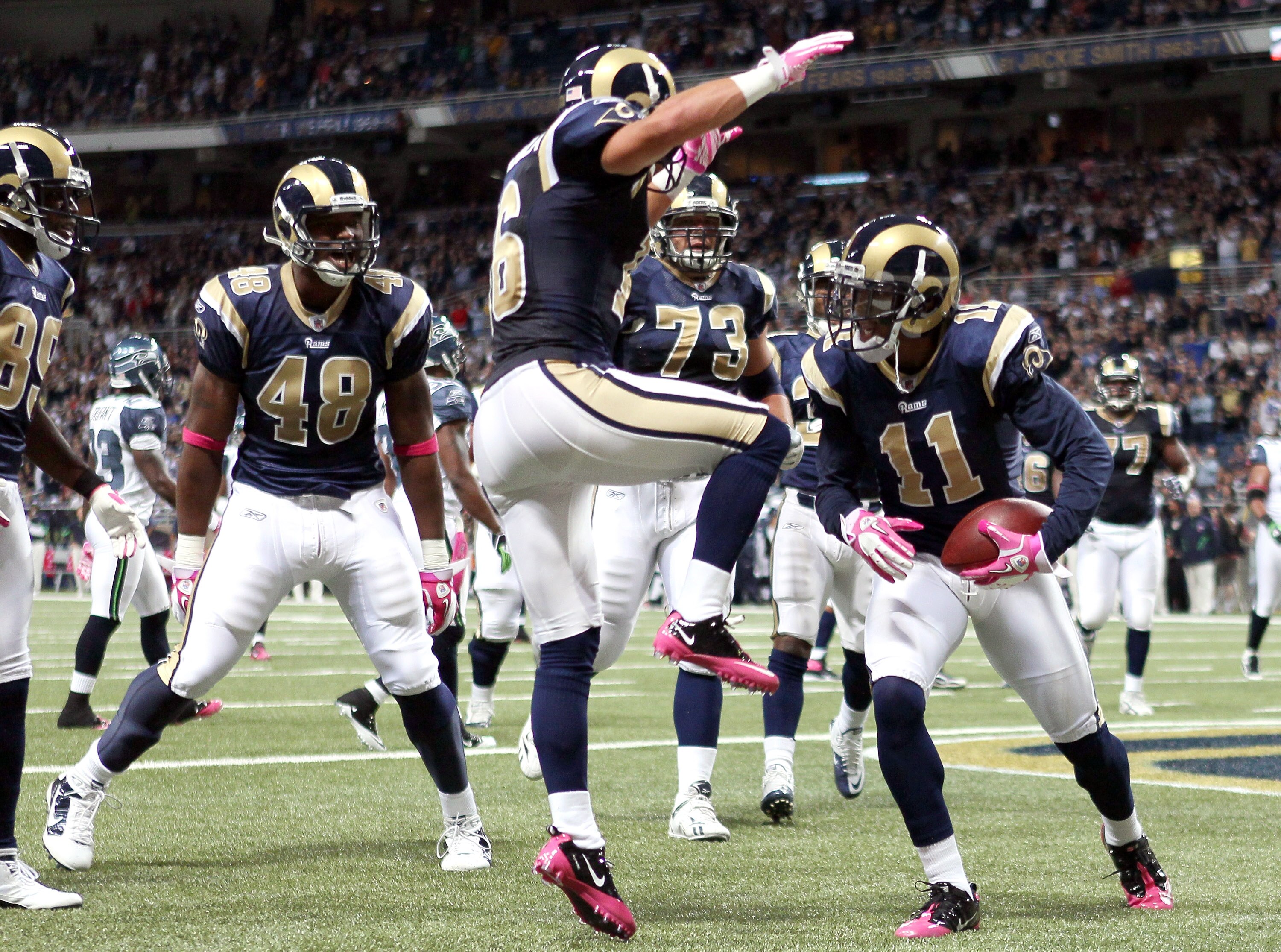 ST. LOUIS - OCTOBER 03: Brandon Gibson #11 of the St. Louis Rams is congratulated by teammates Danny Amendola #16,Fendi Onobun #48 and Adam Goldberg #73 after Gibson scored a touchdown in the first half against the Seattle Seahawks on October 3, 2010 at E