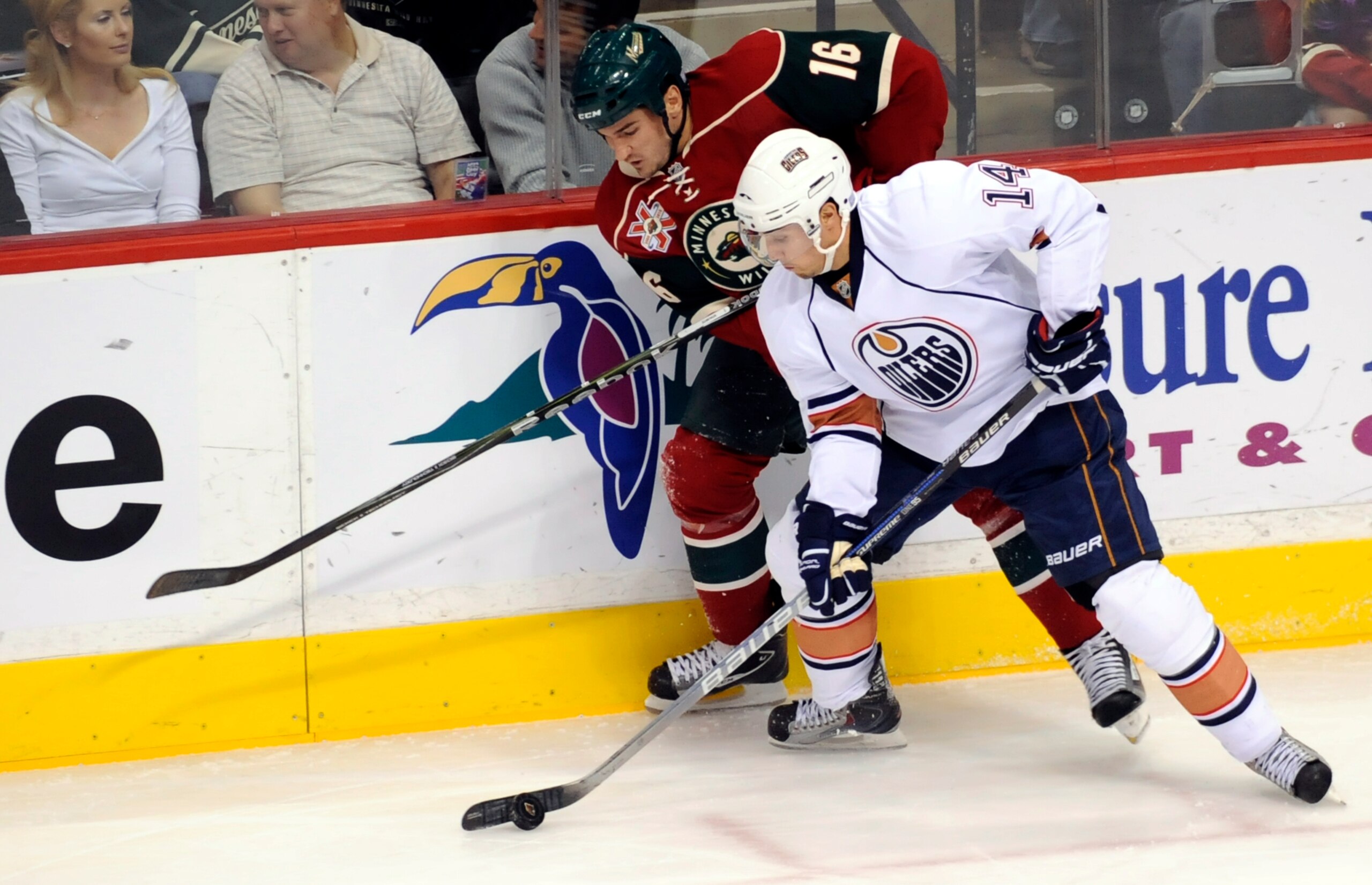 ST PAUL, MN - OCTOBER 14: Jordan Eberle #14 of the Edmonton Oilers checks Brad Staubitz #16 of the Minnesota Wild during their game on October 14, 2010 at Xcel Energy Center in St Paul, Minnesota. (Photo by Hannah Foslien /Getty Images)