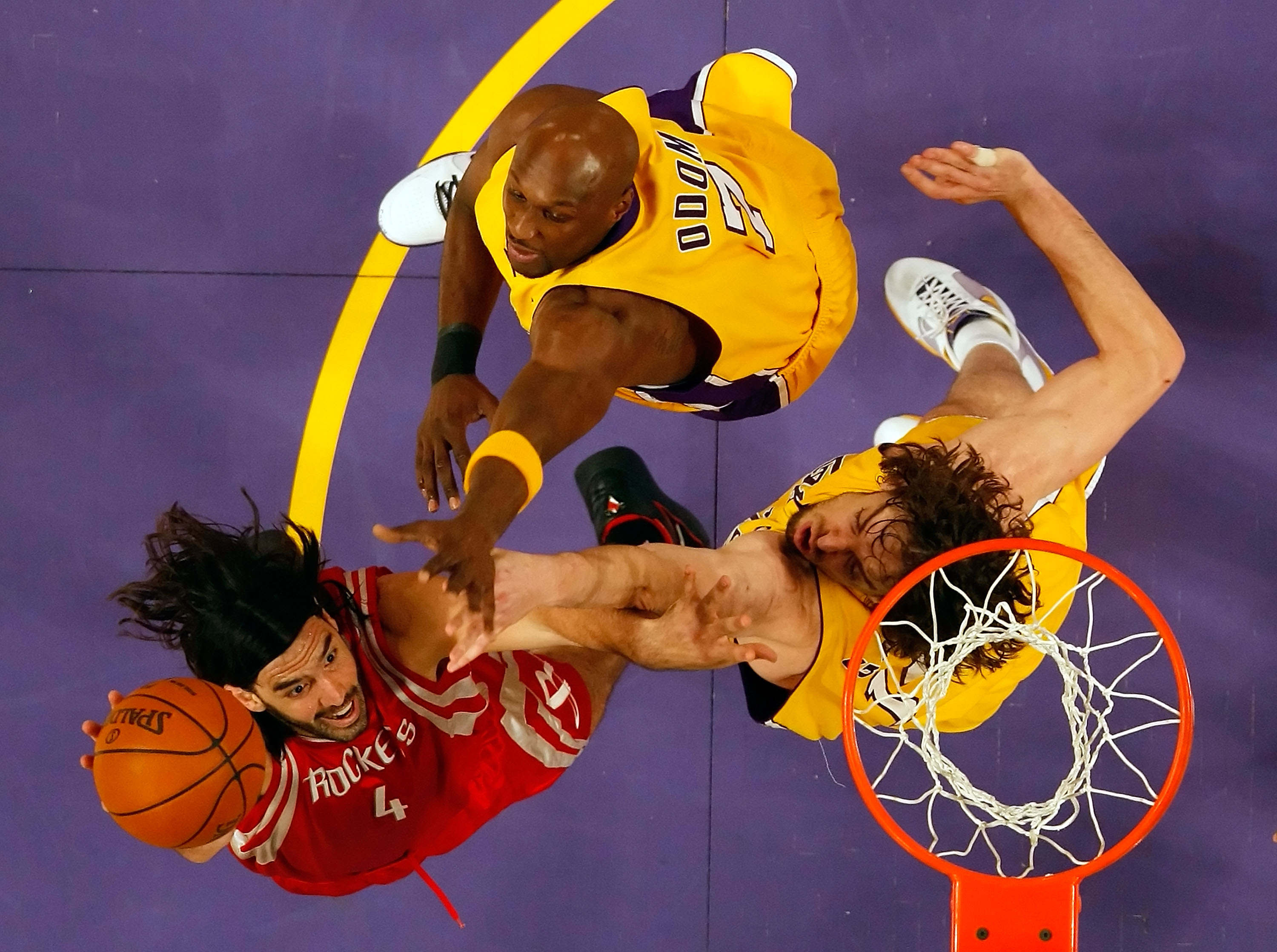 LOS ANGELES, CA - MAY 12:  Luis Scola #4 of the Houston Rockets goes up for a shot over Lamar Odom #7 and Pau Gasol #16 of the Los Angeles Lakers in Game Five of the Western Conference Semifinals during the 2009 NBA Playoffs at Staples Center on May 12, 2