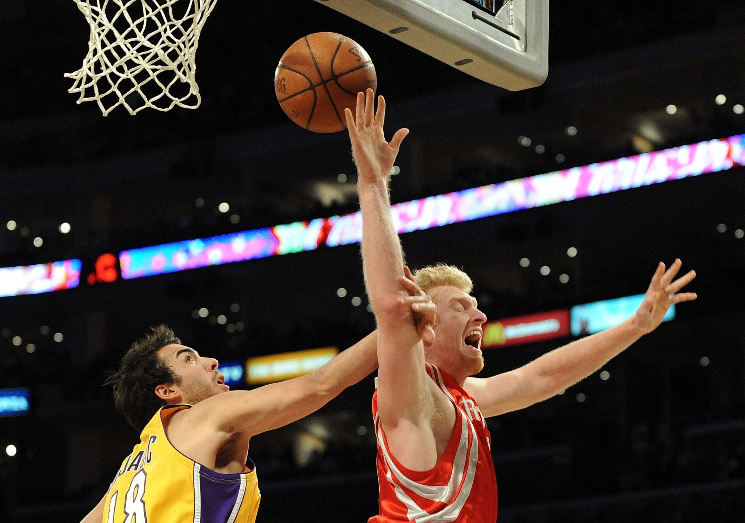 LOS ANGELES, CA - JANUARY 05:  Chase Budinger #10 of the Houston Rockets is fouled on a layup by Sasha Vujacic #18 of the Los Angeles Lakers during the second half at Staples Center on January 5, 2010 in Los Angeles, California.  NOTE TO USER: User expres