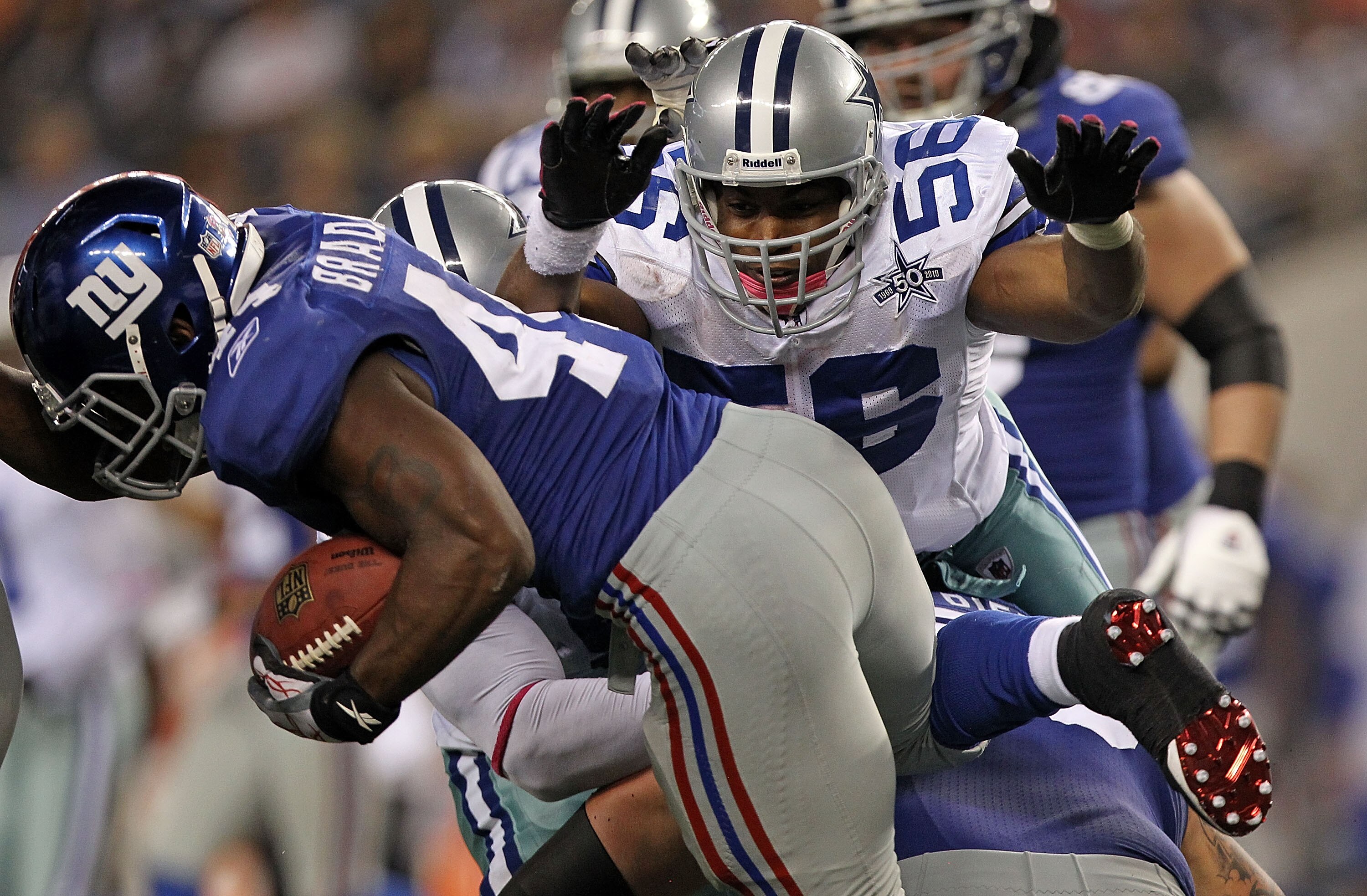 ARLINGTON, TX - OCTOBER 25:  Linebacker Bradie James #56 of the Dallas Cowboys dives for a tackle on Ahmad Bradshaw #44 of the New York Giants at Cowboys Stadium on October 25, 2010 in Arlington, Texas.  (Photo by Ronald Martinez/Getty Images)