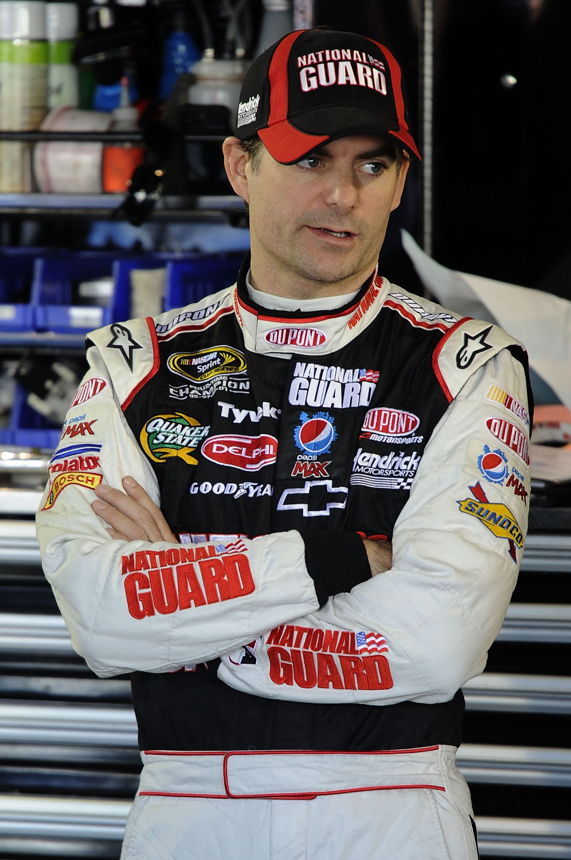 MARTINSVILLE, VA - OCTOBER 23:  Jeff Gordon, driver of the #24 DuPont/National Guard Families Chevrolet, stands in the garage during practice for the NASCAR Sprint Cup Series TUMS Fast Relief 500 at Martinsville Speedway on October 23, 2010 in Martinsvill