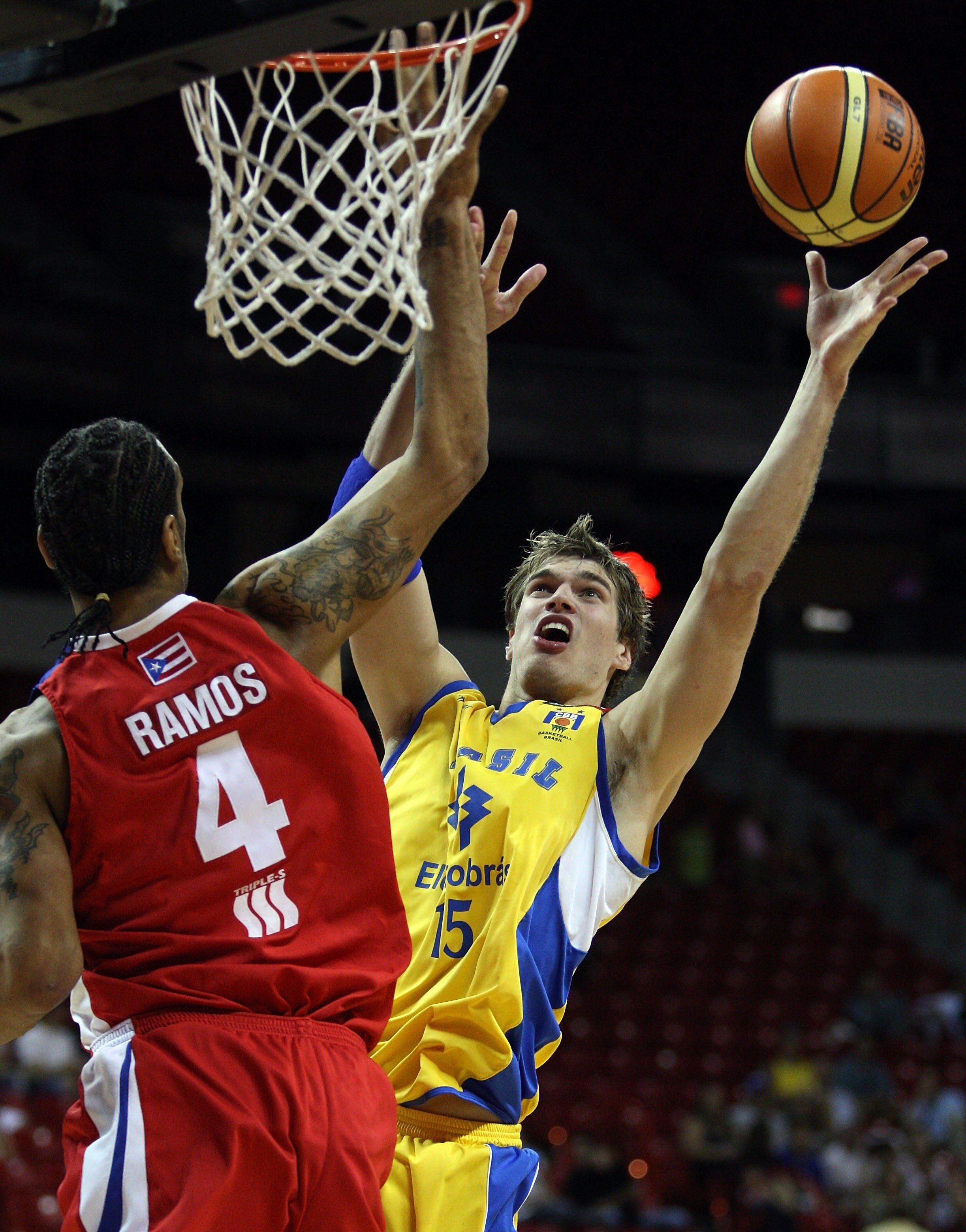 LAS VEGAS - SEPTEMBER 2:  Tiago Splitter #15 of Brazil shoots over Peter J. Ramos #4 of Puerto Rico during the FIBA Americas Championship 2007 Bronze Medal game at Thomas & Mack Center September 2, 2007 in Las Vegas, Nevada.  (Photo by Jamie Squire/Getty