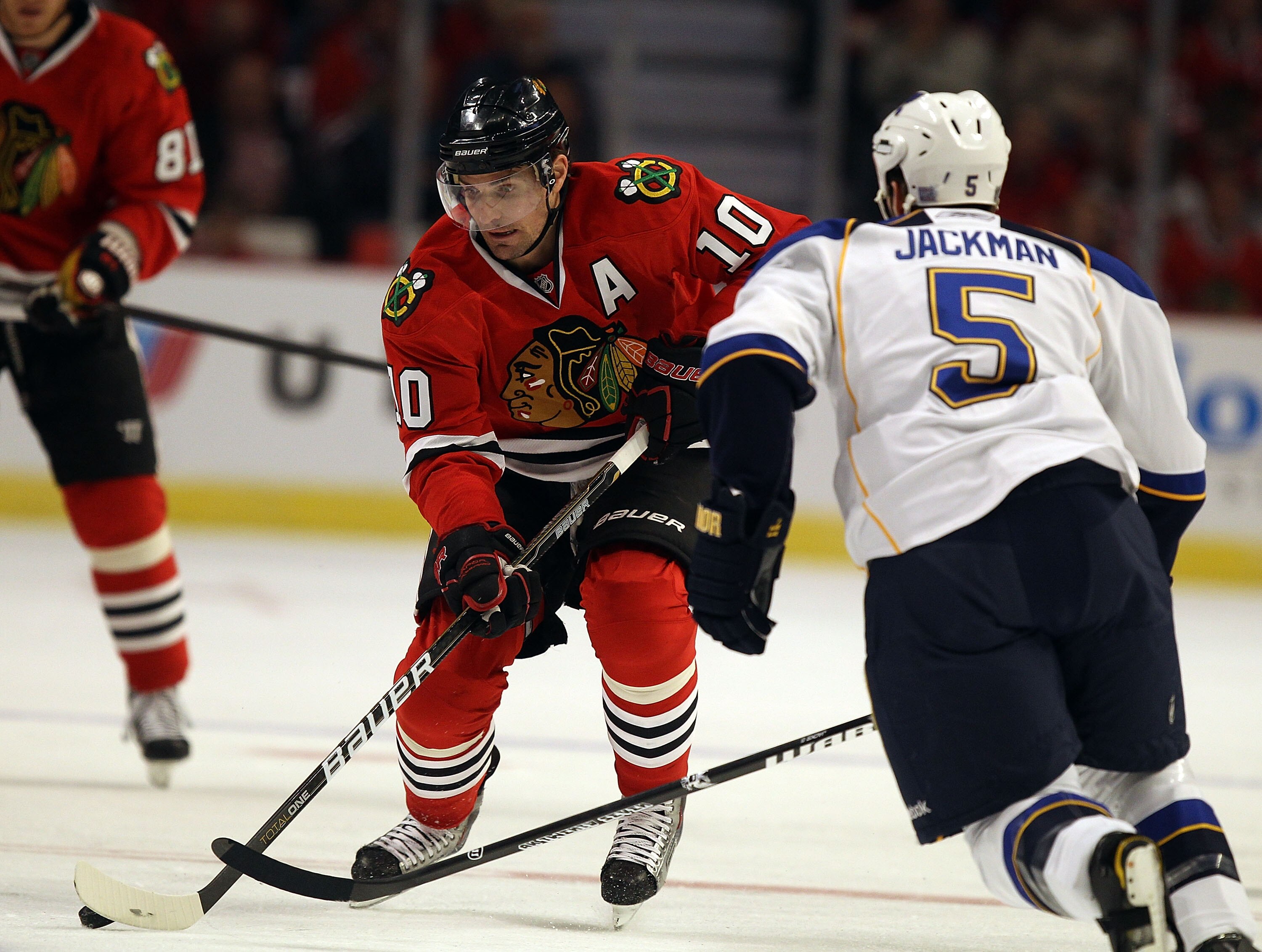 CHICAGO - OCTOBER 18: Patrick Sharp #10 of the Chicago Blackhawks looks to pass against Barret Jackman #5 of the St. Louis Blues at the United Center on October 18, 2010 in Chicago, Illinois. The Blackhawks defeated the Blues 3-2 in overtime.  (Photo by J