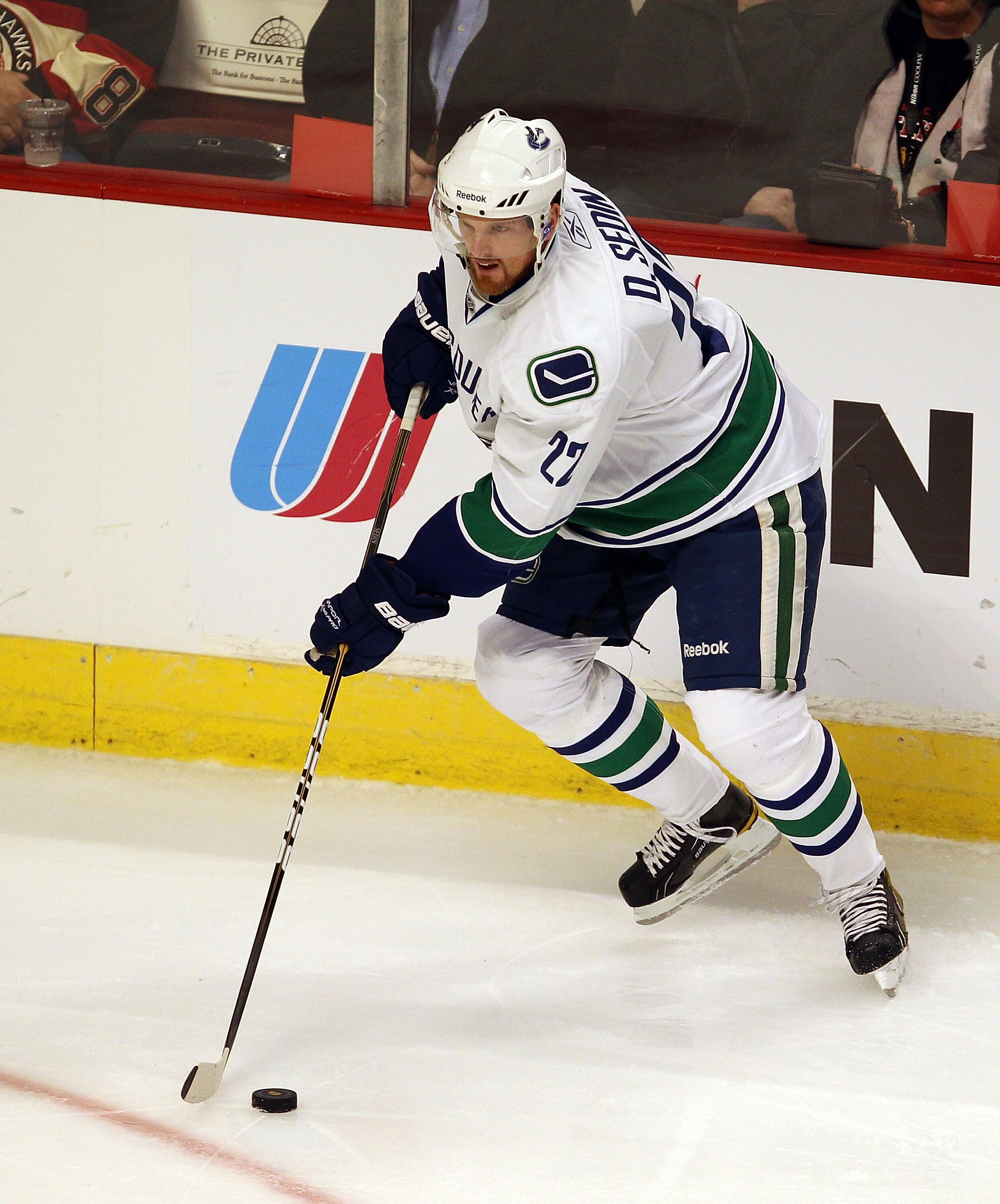 CHICAGO - OCTOBER 20: Daniel Sedin #22 of the Vancouver Canucks controls the puck against the Chicago Blackhawks at the United Center on October 20, 2010 in Chicago, Illinois. The Blackhawks defeated the Canucks 2-1 in a shootout. (Photo by Jonathan Danie