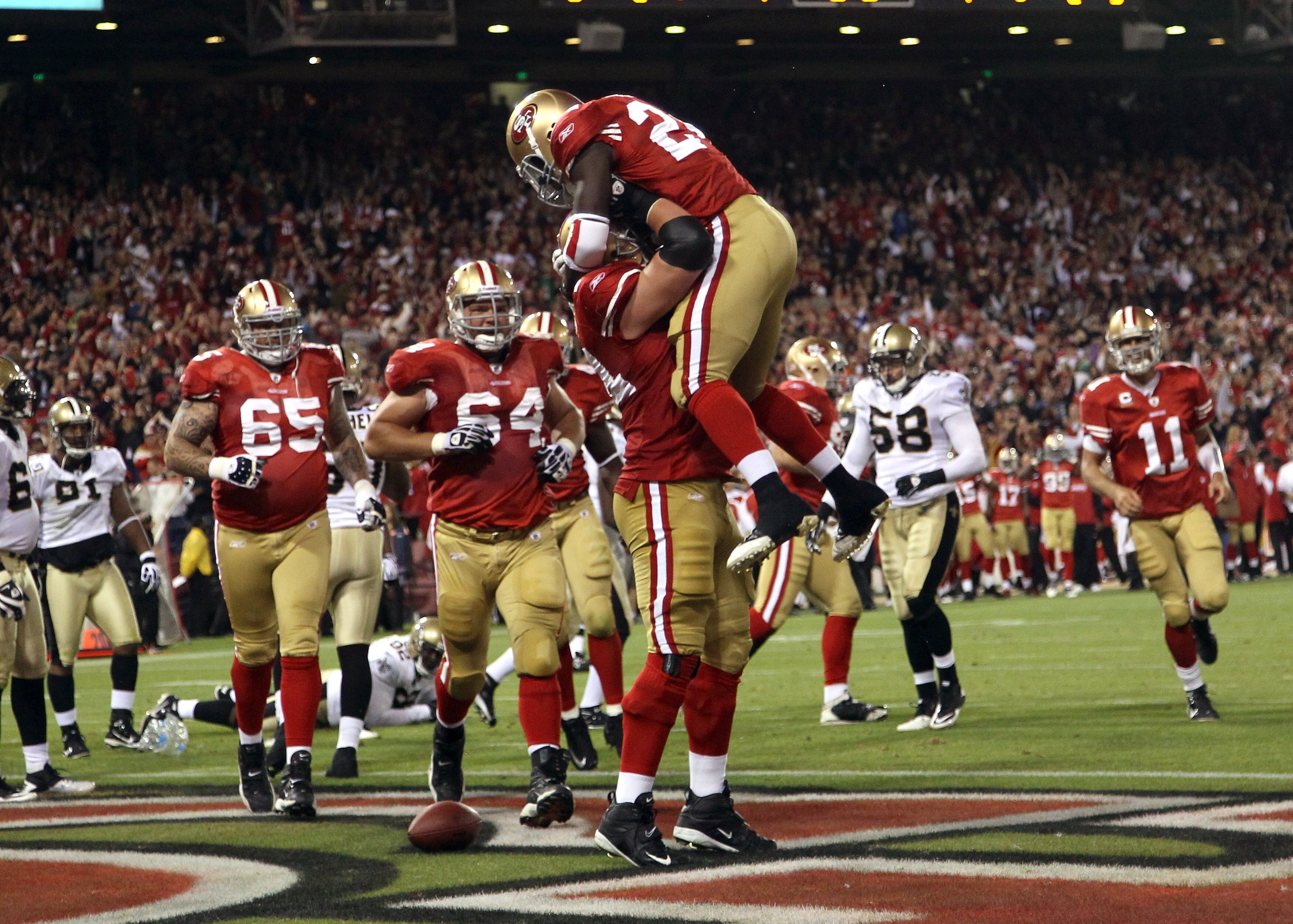 SAN FRANCISCO - SEPTEMBER 20:  Joe Staley #74 lifts up Anthony Dixon #24 of the San Francisco 49ers after Dixon scored a touchdown against the New Orleans Saints at Candlestick Park on September 20, 2010 in San Francisco, California.  (Photo by Ezra Shaw/