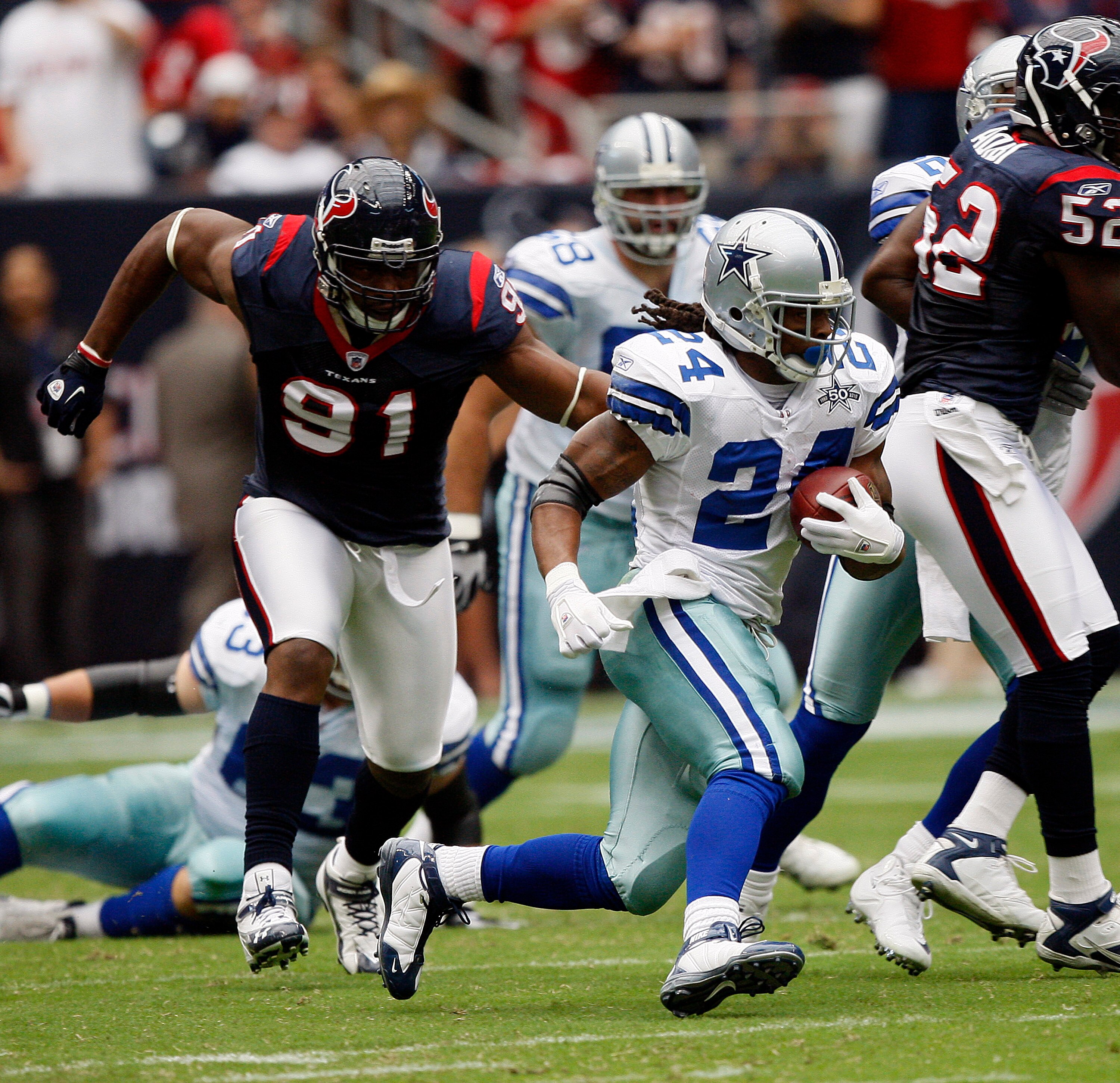 HOUSTON - SEPTEMBER 26:  Running back Marion Barber #24 of the Dallas Cowboys rushes past defensive tackle Amobi Okoye #91 of the Houston Texans at Reliant Stadium on September 26, 2010 in Houston, Texas.  (Photo by Bob Levey/Getty Images)
