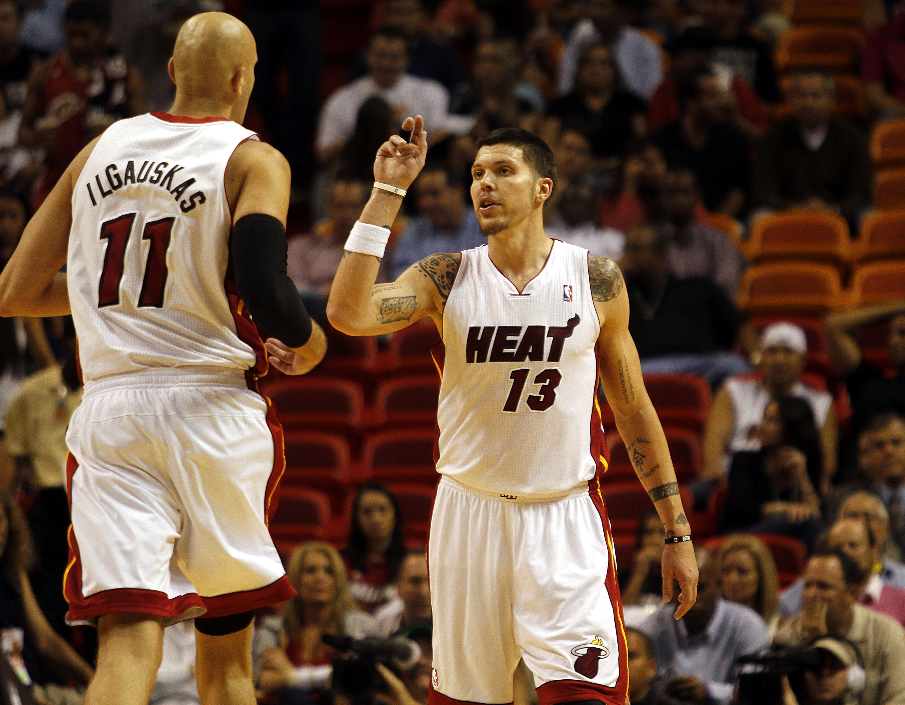 MIAMI - OCTOBER 18:  Center Zydrunas Ilgauskas #11 and Forward Mike Miller #13 of the Miami Heat celebrate against the Charlotte Bobcats on October 18, 2010 at American Airlines Arena in Miami, Florida. NOTE TO USER: User expressly acknowledges and agrees