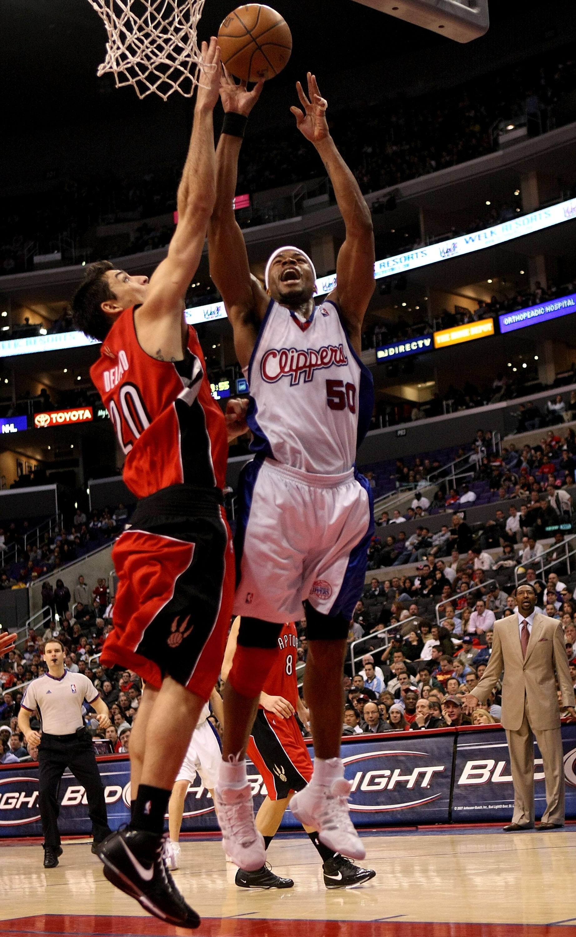 LOS ANGELES - DECEMBER 18:  Corey Maggette #50 of the Los Angeles Clippers makes a basket over Carlos Delfino #20 of the Toronto Raptors on December 18, 2007 at Staples Center in Los Angeles, California.  The Raptors won 80-77. NOTE TO USER: User expressl