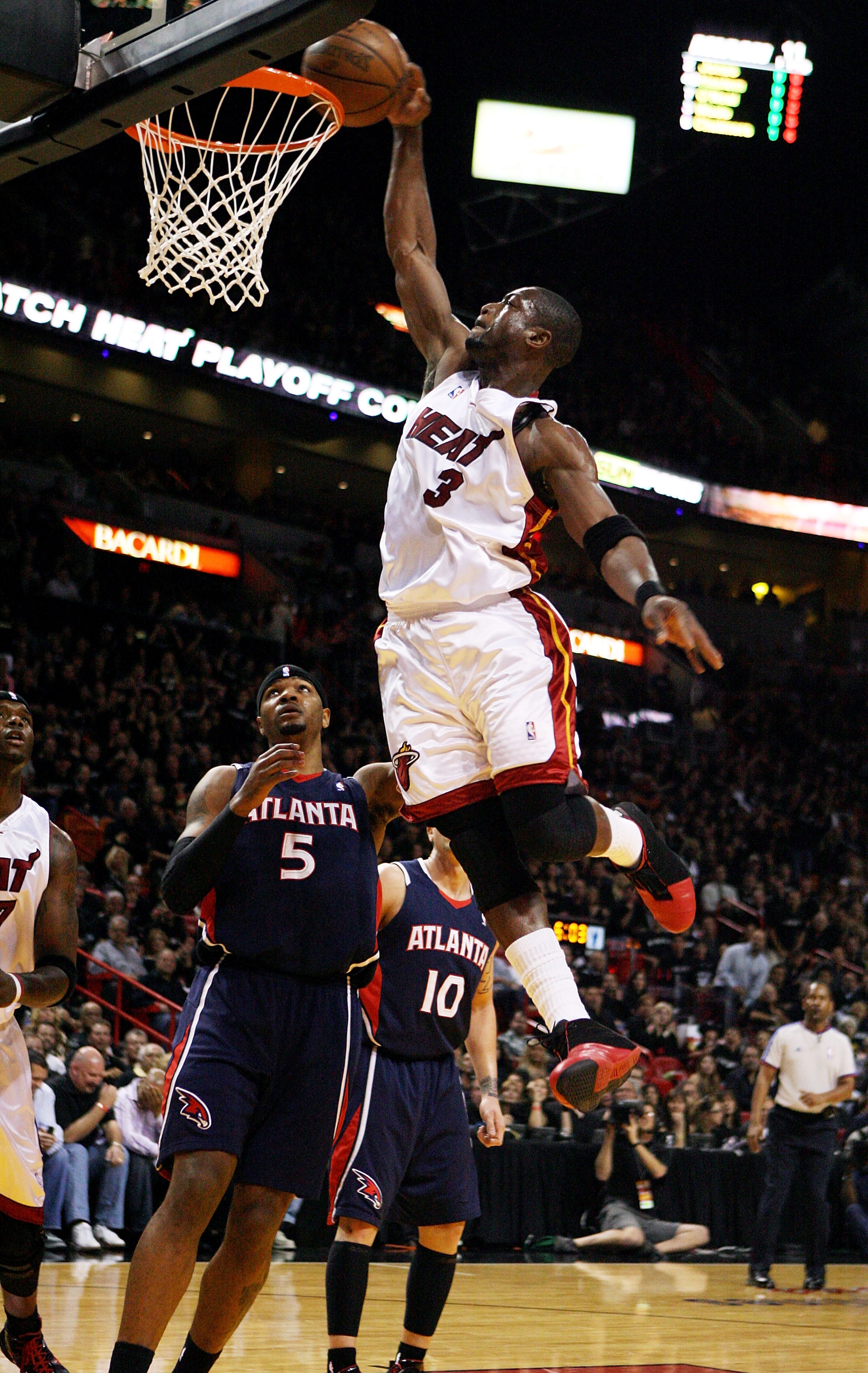 MIAMI - APRIL 25:  Dwyane Wade #3 of the Miami Heat dunks over Josh Smith #5 of the Atlanta Hawks during Game Three of the Eastern Conference Quarterfinals at American Airlines Arena on April 25, 2009 in Miami, Florida. NOTE TO USER: User expressly acknow