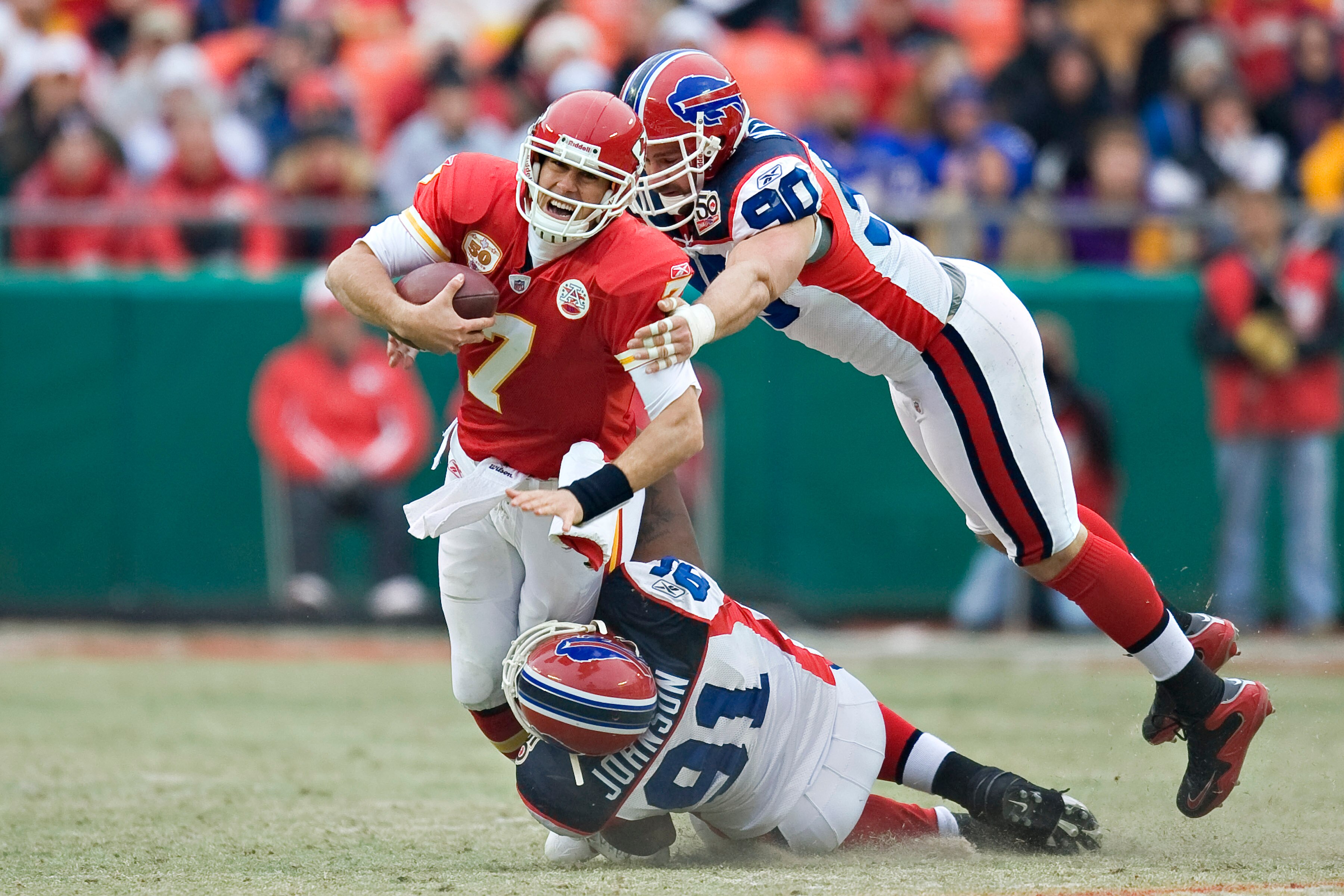 KANSAS CITY, MO - DECEMBER 13: Quarterback Matt Cassel #7 of the Kansas City Chiefs is sacked by defensive tackle Spencer Johnson #91 and defensive end Chris Kelsay #90 of the Buffalo Bills at Arrowhead Stadium on December 13, 2009 Kansas City, Missouri. 