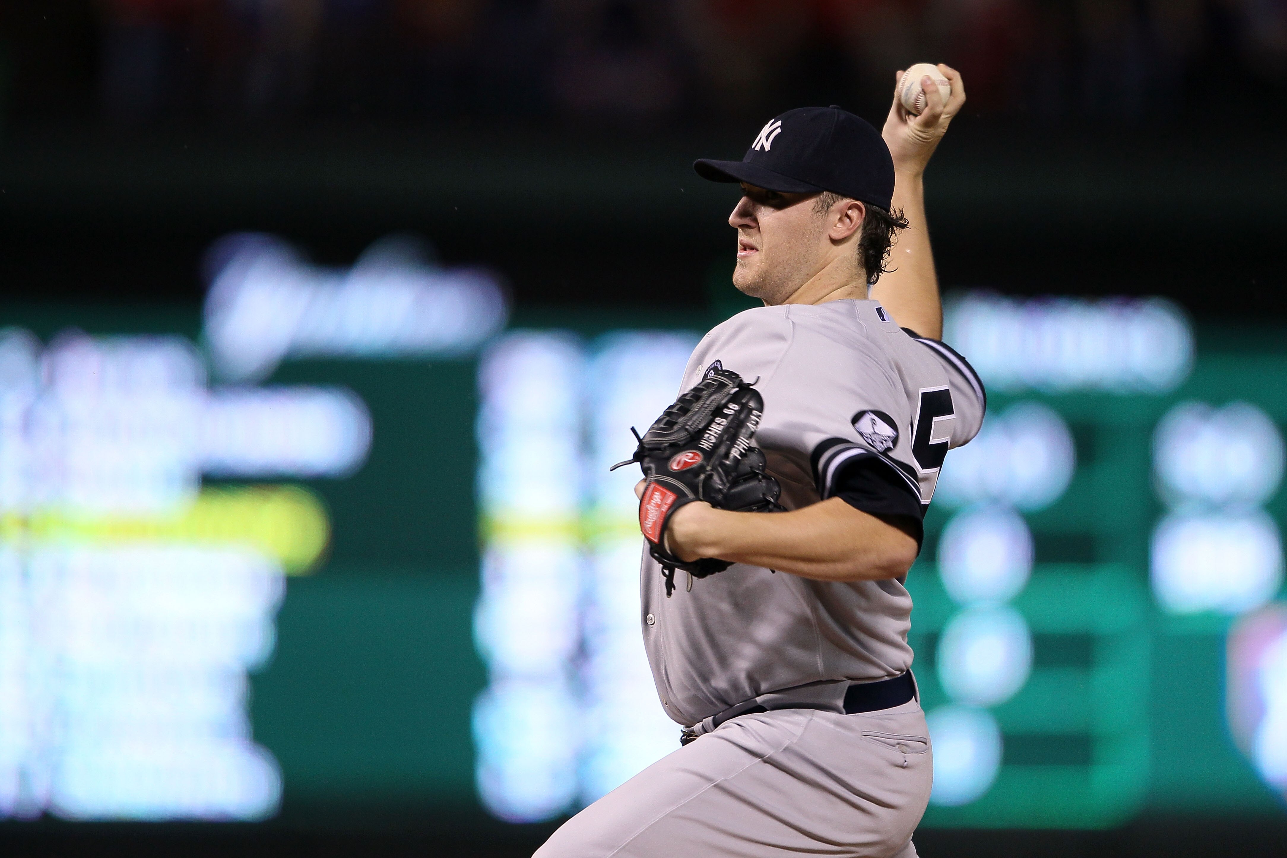 ARLINGTON, TX - OCTOBER 22:  Starting pitcher Phil Hughes #65 of the New York Yankees throws a pitch against the New York Yankees in the first inning of Game Six of the ALCS during the 2010 MLB Playoffs at Rangers Ballpark in Arlington on October 22, 2010