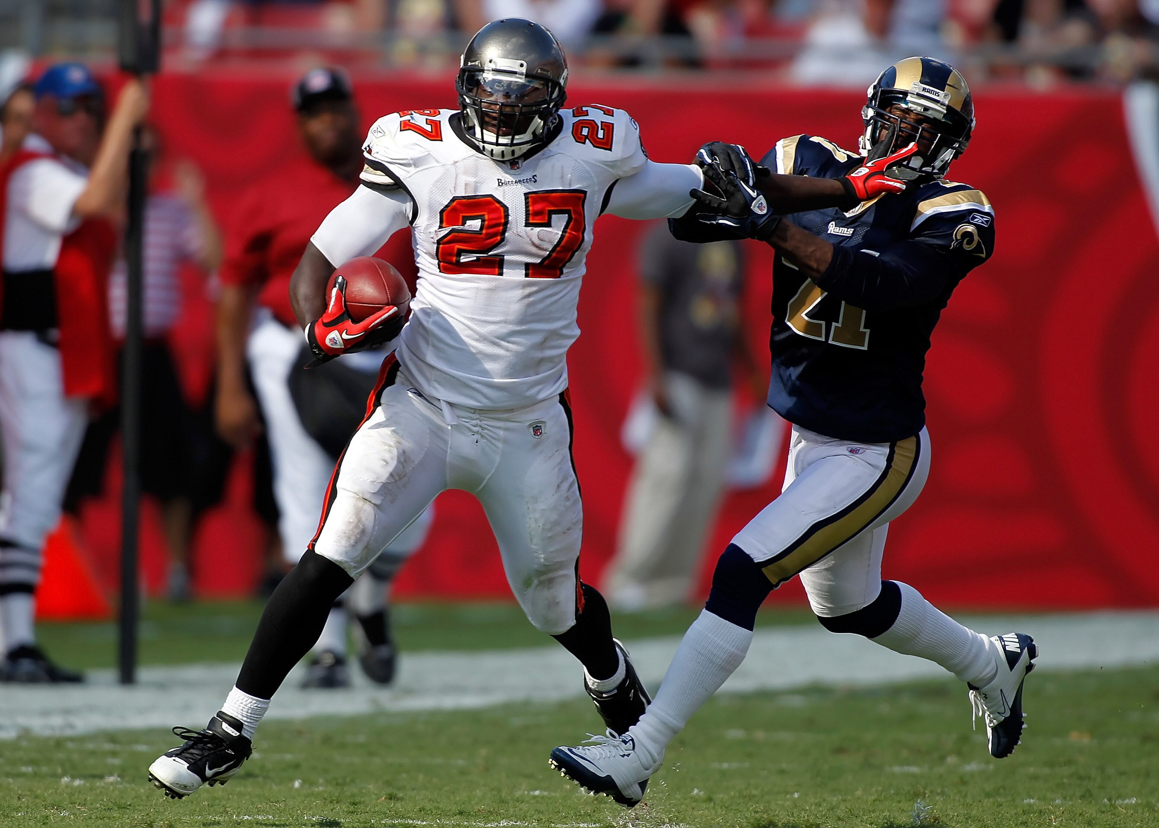 TAMPA, FL - OCTOBER 24:  Running back LeGarrette Blount #27 of the Tampa Bay Buccaneers straight arms safety Oshiomogho Atogwe #21 of the St. Louis Rams during the game at Raymond James Stadium on October 24, 2010 in Tampa, Florida.  (Photo by J. Meric/Ge