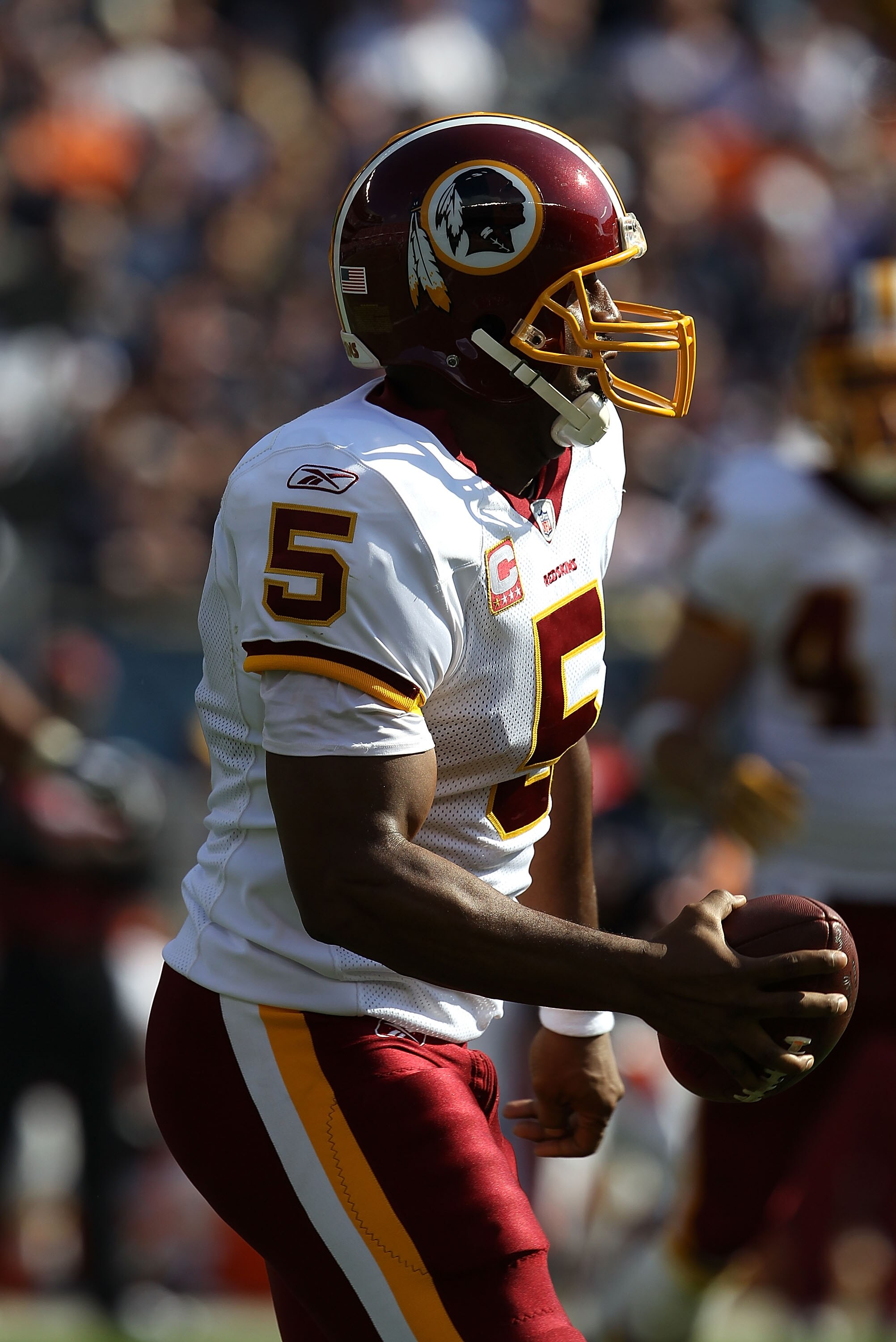 CHICAGO - OCTOBER 24: Donovan McNabb #5 of the Washington Redskins rolls out to look for a receiver against the Chicago Bears at Soldier Field on October 24, 2010 in Chicago, Illinois.  The Redskins defeated the Bears 17-14. (Photo by Jonathan Daniel/Gett