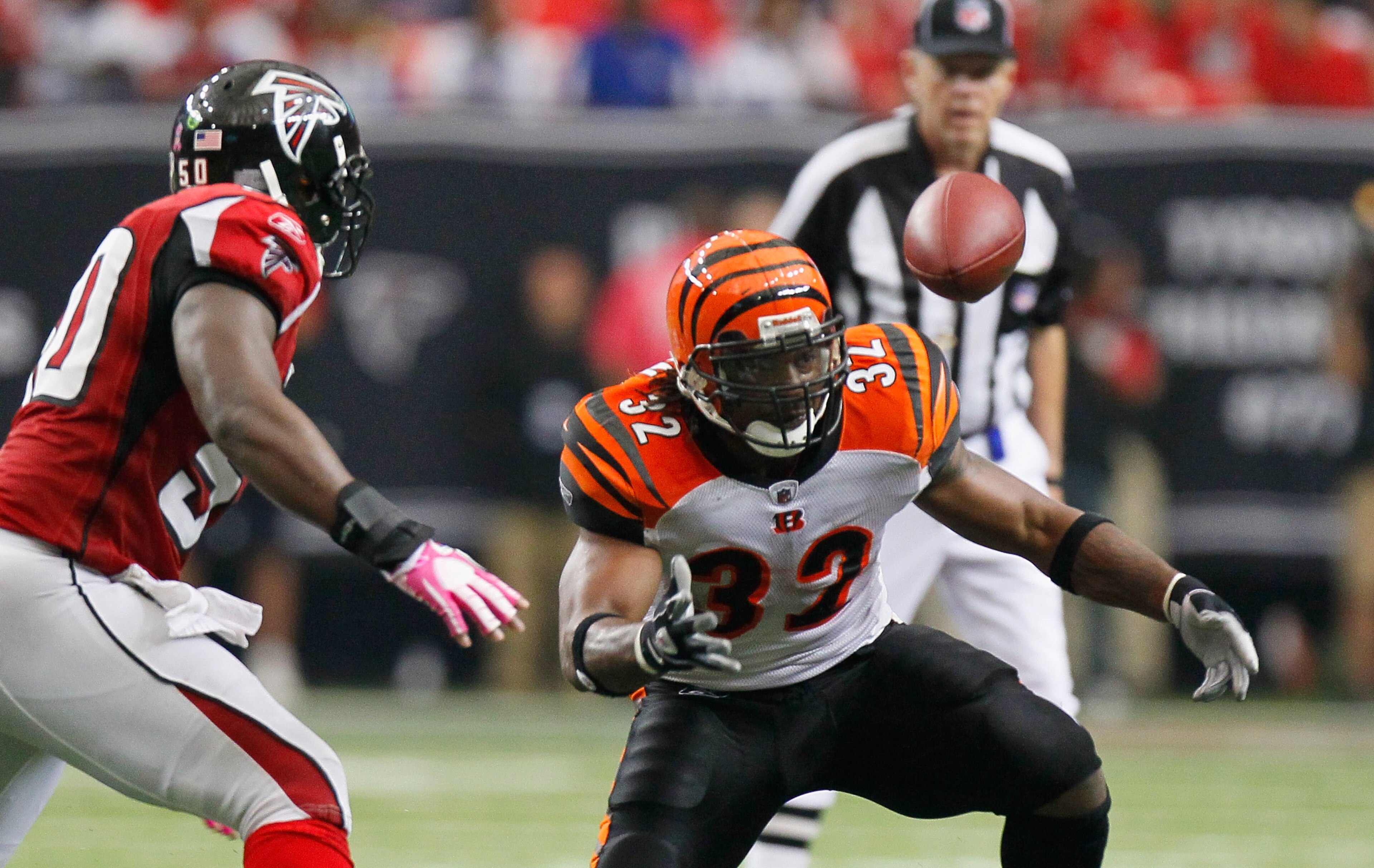 ATLANTA - OCTOBER 24:  Cedric Benson #32 of the Cincinnati Bengals fumbles the ball against Curtis Lofton #50 of the Atlanta Falcons at Georgia Dome on October 24, 2010 in Atlanta, Georgia.  (Photo by Kevin C. Cox/Getty Images)