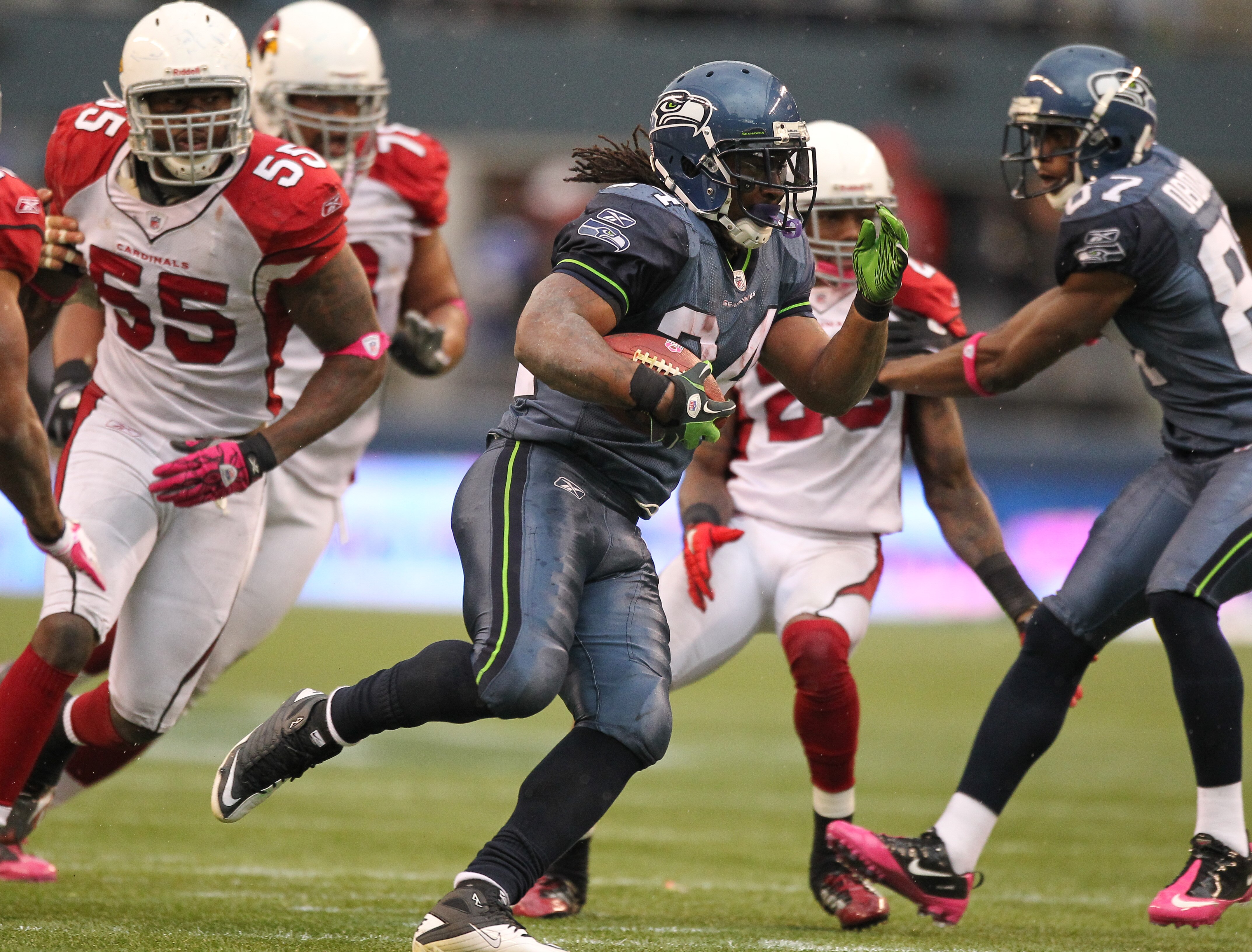 SEATTLE - OCTOBER 24:  Running back Marshawn Lynch #24 of the Seattle Seahawks rushes against Joey Porter #55 of the Arizona Cardinals at Qwest Field on October 24, 2010 in Seattle, Washington. (Photo by Otto Greule Jr/Getty Images)