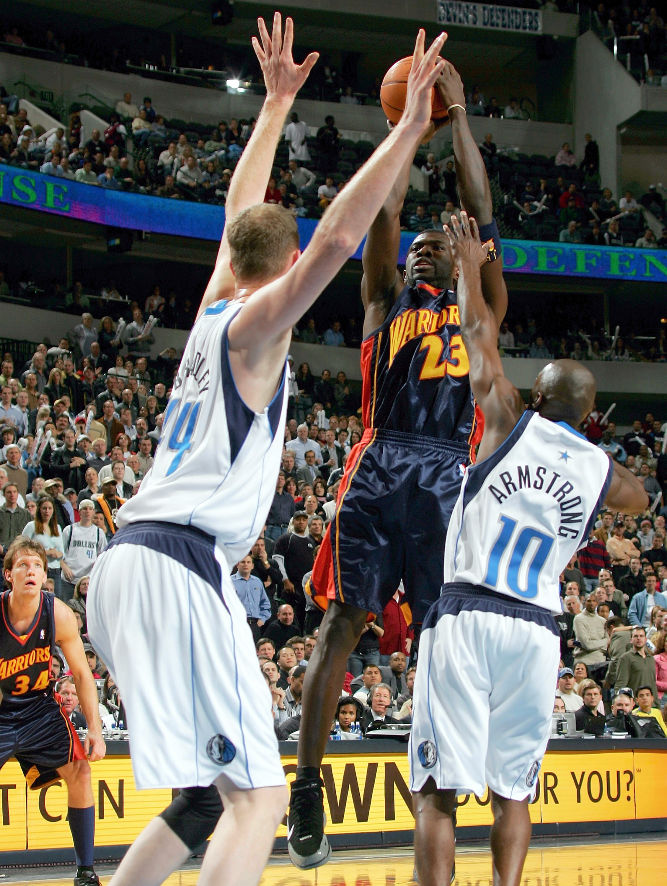 DALLAS - DECEMBER 14: Guard Jason Richardson #23 of the Golden State Warriors takes a shot against Shawn Bradley #44 and Darrell Armstrong #10 of the Dallas Mavericks on December 14, 2004 at the American Airlines Center in Dallas, Texas.   (Photo by Ronal