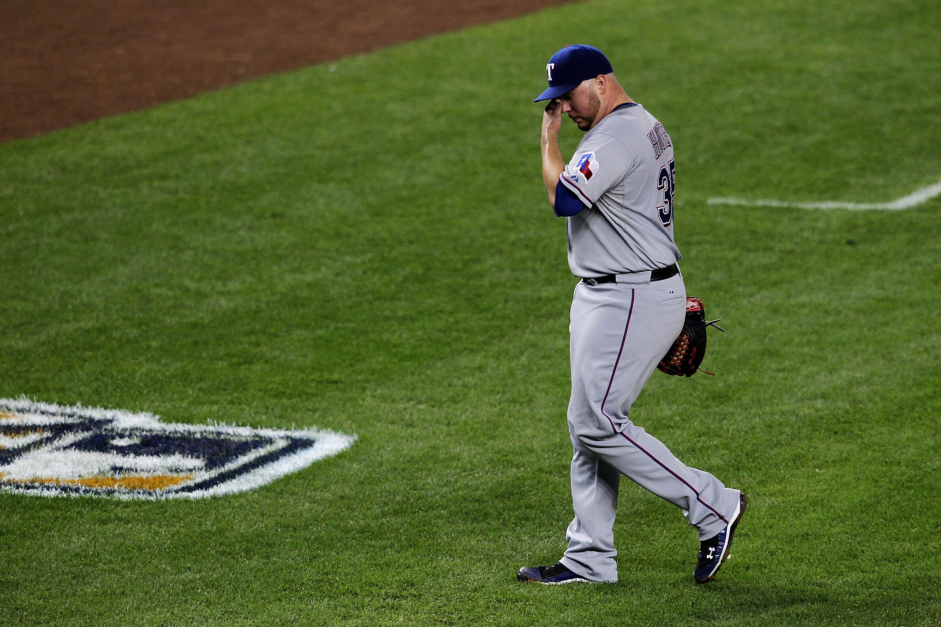 NEW YORK - OCTOBER 19:  Tommy Hunter #35 of the Texas Rangers walks back to the dugout after he was taken out of the game in the bottom of the fourth inning against the New York Yankees in Game Four of the ALCS during the 2010 MLB Playoffs at Yankee Stadi