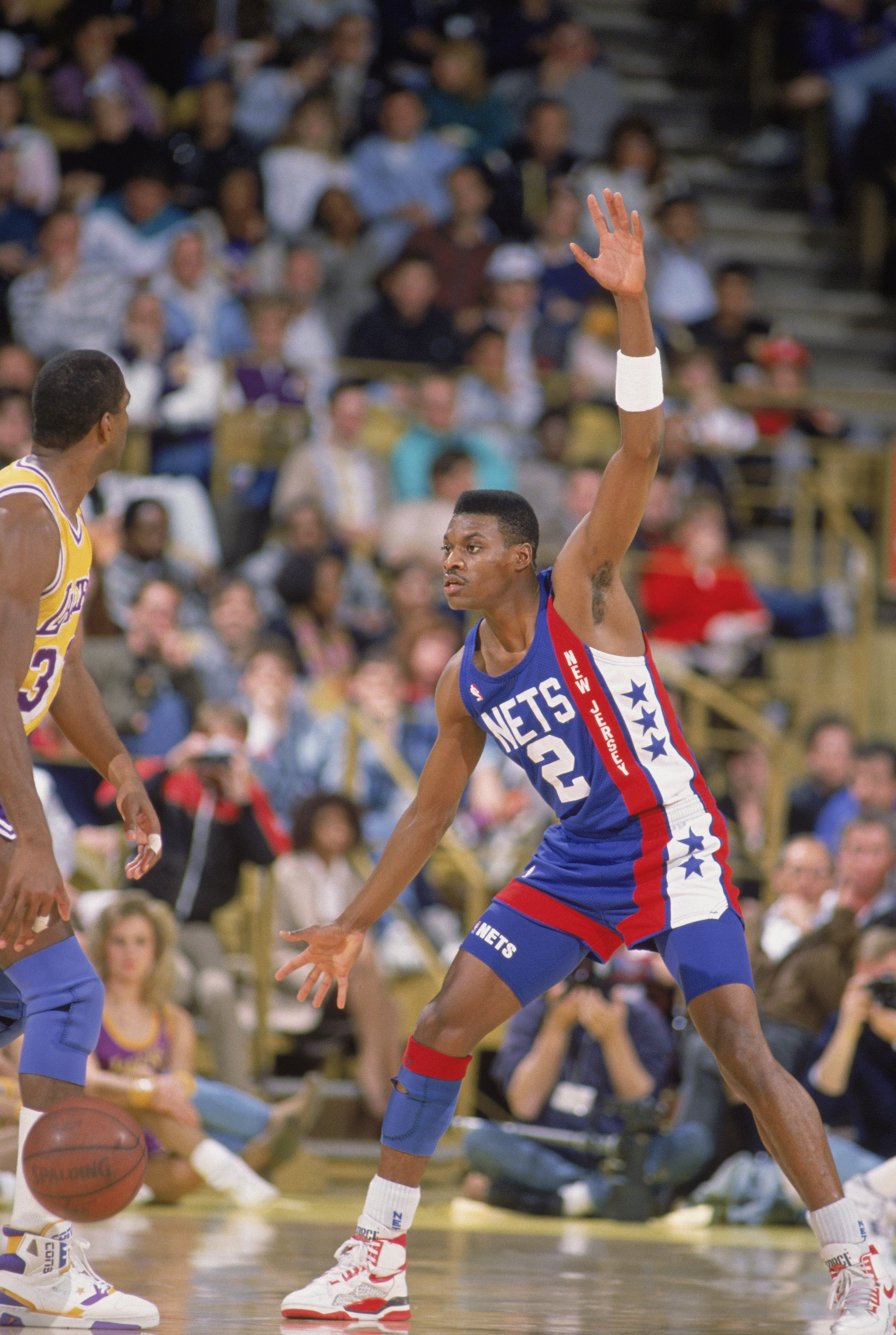 LOS ANGELES - 1990:  Dennis Hopson #2 of the New Jersey Nets defends Magic Johnson #32 of the Los Angeles Lakers during the NBA game at the Great Western Forum in Los Angeles, California in 1990. NOTE TO USER: User expressly acknowledges and agrees that,