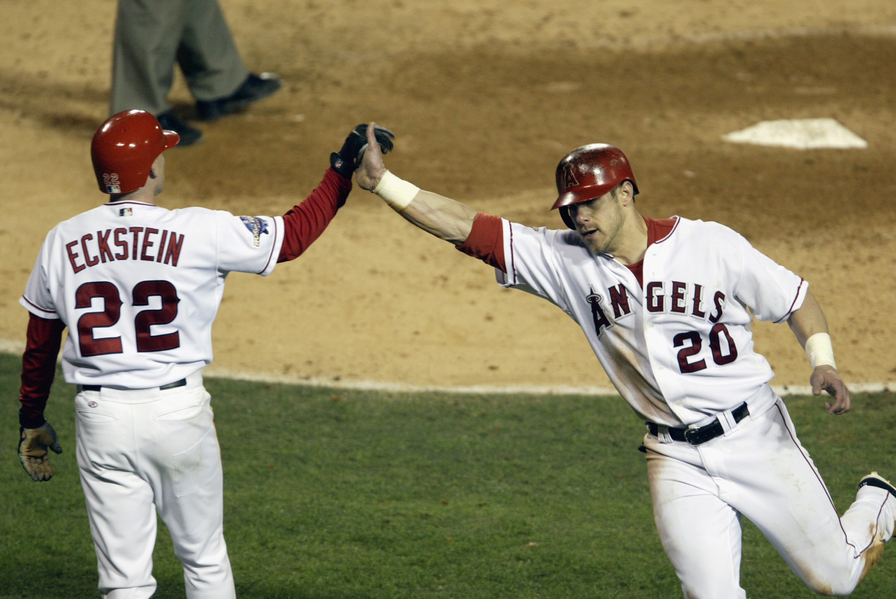 ANAHEIM, CA - OCTOBER 19: Designated hitter Brad Fullmer #20 of the Anaheim Angels is congratulated by teammate shortstop David Eckstein #22 after crossing home plate on a RBI single by second baseman Adam Kennedy in the sixth inning of game one of the W ANAHEIM, CA - OCTOBER 19: Designated hitter Brad Fullmer #20 of the Anaheim Angels is congratulated by teammate shortstop David Eckstein #22 after crossing home plate on a RBI single by second baseman Adam Kennedy in the sixth inning of game one of the W