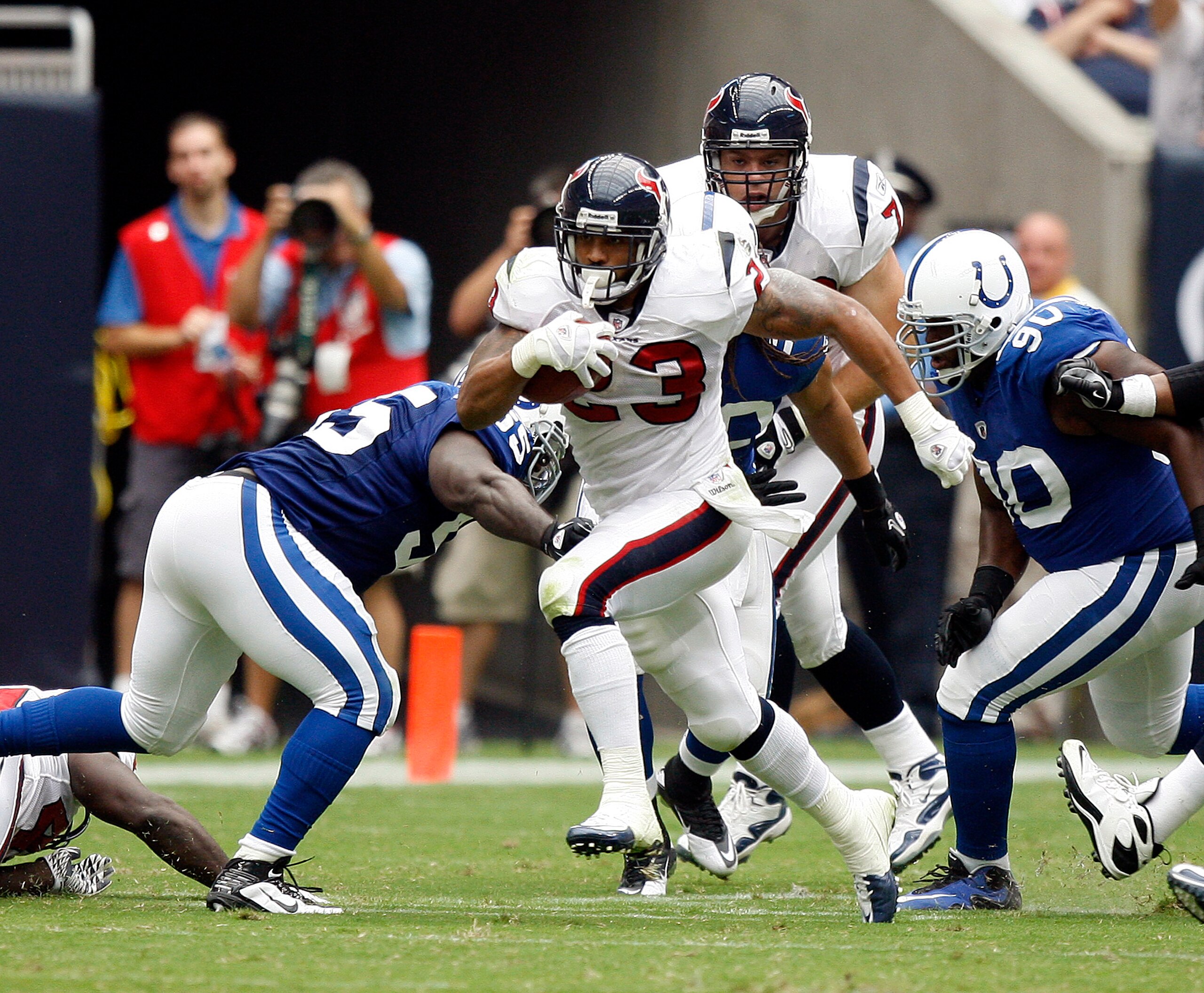 HOUSTON - SEPTEMBER 12:  Running back Arian Foster #23 of the Houston Texans rushes past defensive tackle Daniel Muir #90 of the Indianapolis Colts in  the first quarter  during the NFL season opener at Reliant Stadium on September 12, 2010 in Houston, Te