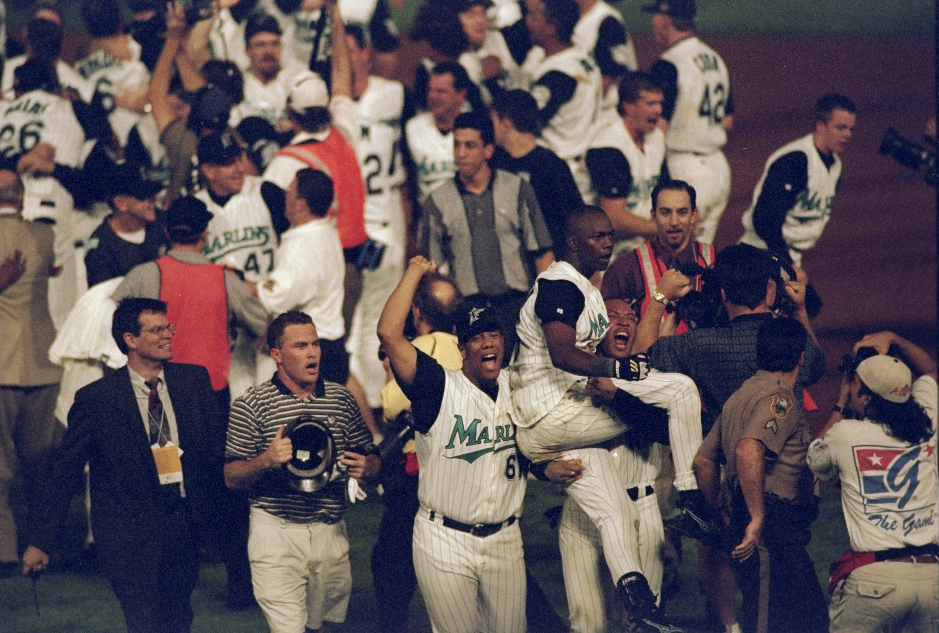 26 Oct 1997: Shortstop Edgar Renteria of the Florida Marlins is carried by teammates outfielder Gary Sheffield and pitcher Livan Hernandez after 11 innings of the 7th game of the 1997 World Series against the Cleveland Indians at Pro Player Stadium in 26 Oct 1997: Shortstop Edgar Renteria of the Florida Marlins is carried by teammates outfielder Gary Sheffield and pitcher Livan Hernandez after 11 innings of the 7th game of the 1997 World Series against the Cleveland Indians at Pro Player Stadium in