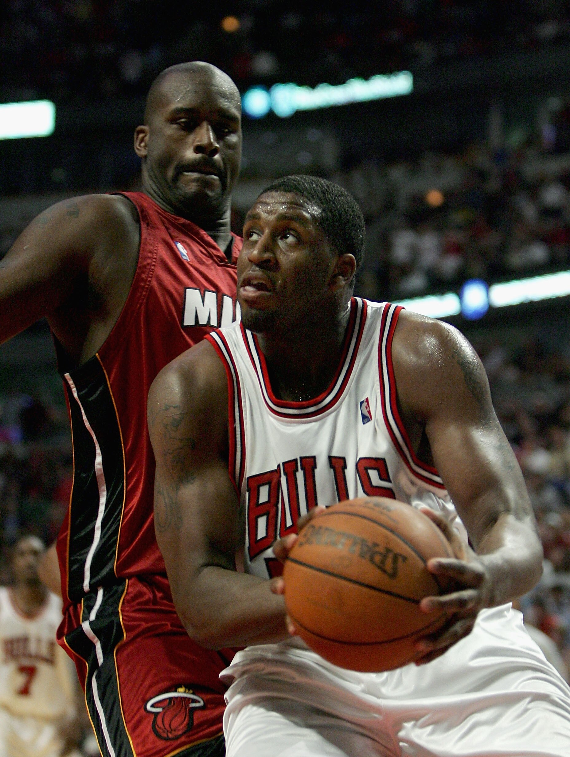 CHICAGO - APRIL 30:   Michael Sweetney #50 of the Chicago Bulls moves past Shaquille O'Neal #32 of the Miami Heat in game four of the Eastern Conference Quarterfinals during the 2006 NBA Playoffs at the United Center on April 30, 2006 in Chicago, Illinois