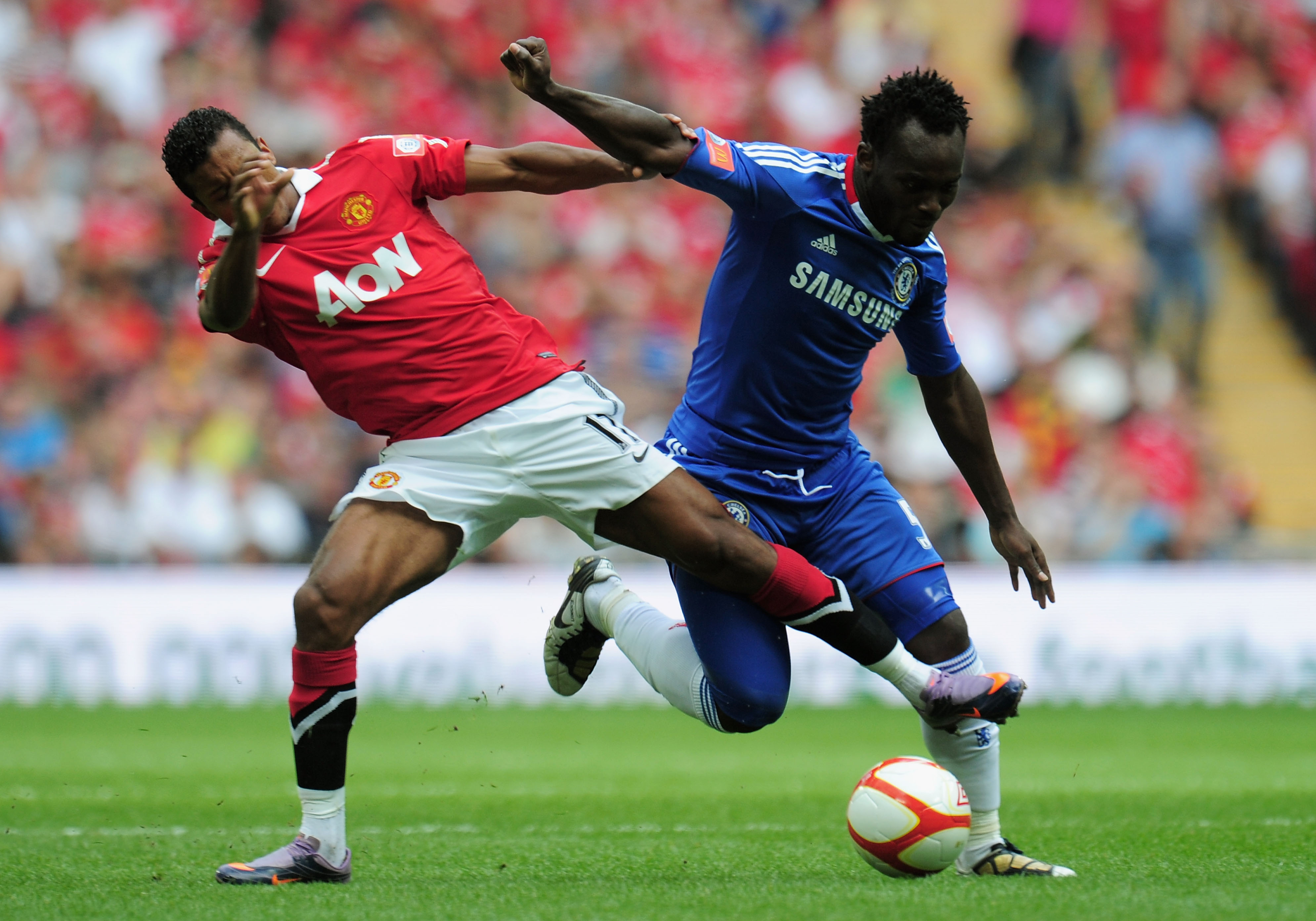 LONDON, ENGLAND - AUGUST 08:  Nani of Manchester United tackles Michael Essien of Chelsea during the FA Community Shield match between Chelsea and Manchester United at Wembley Stadium on August 8, 2010 in London, England.  (Photo by Shaun Botterill/Getty