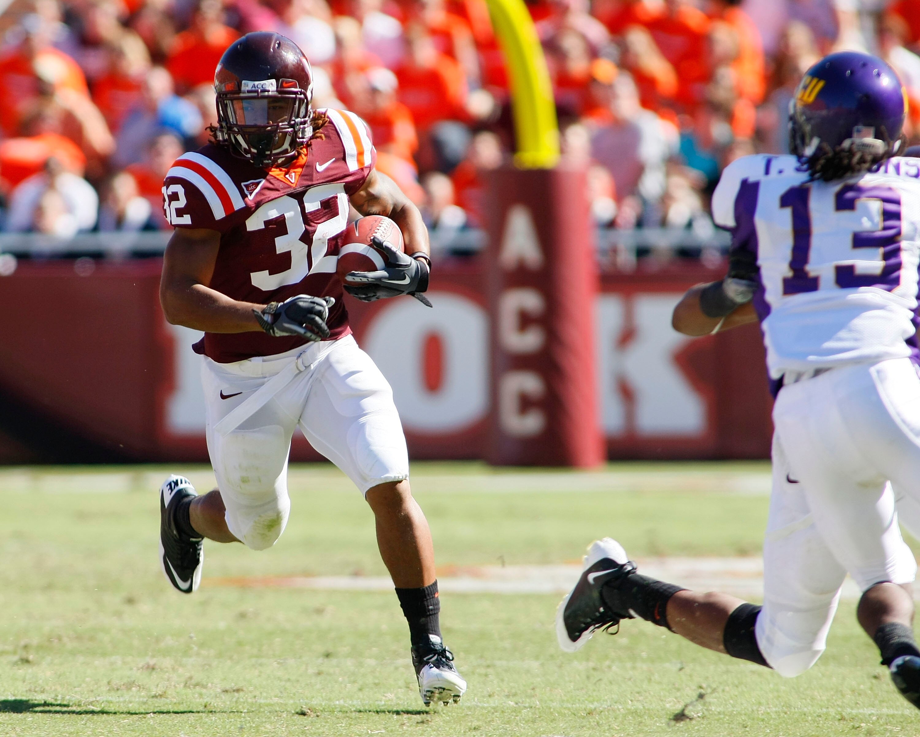 BLACKSBURG, VA - SEPTEMBER 18: Running back Darren Evans #32 of the Virginia Tech Hokies runs with the ball as cornerback Travis Simmons #13 of the East Carolina Pirates defends at Lane Stadium on September 18, 2010 in Blacksburg, Virginia.  (Photo by Geo
