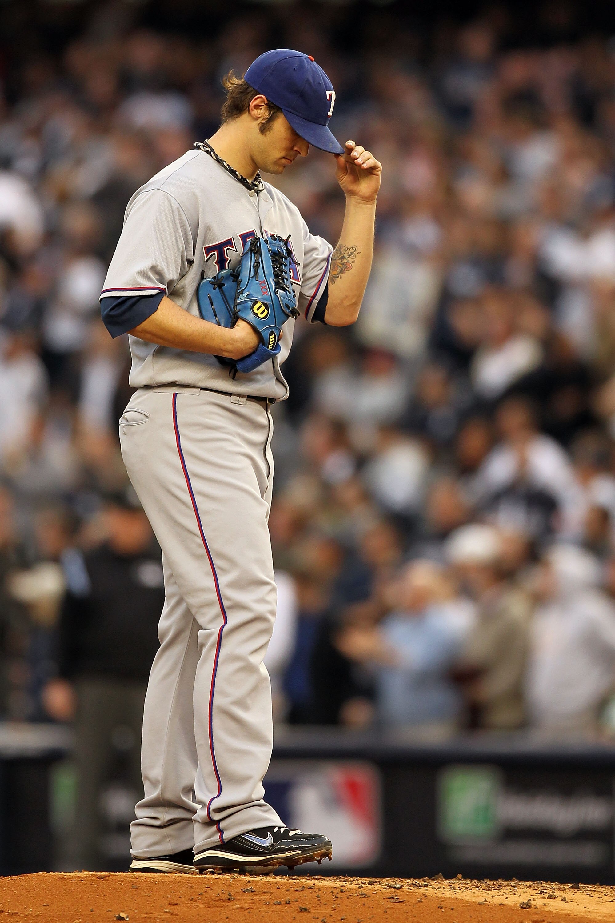 NEW YORK - OCTOBER 20:  Starting pitcher C.J. Wilson #36 of the Texas Rangers looks on against the New York Yankees in Game Five of the ALCS during the 2010 MLB Playoffs at Yankee Stadium on October 20, 2010 in the Bronx borough of New York City.  (Photo