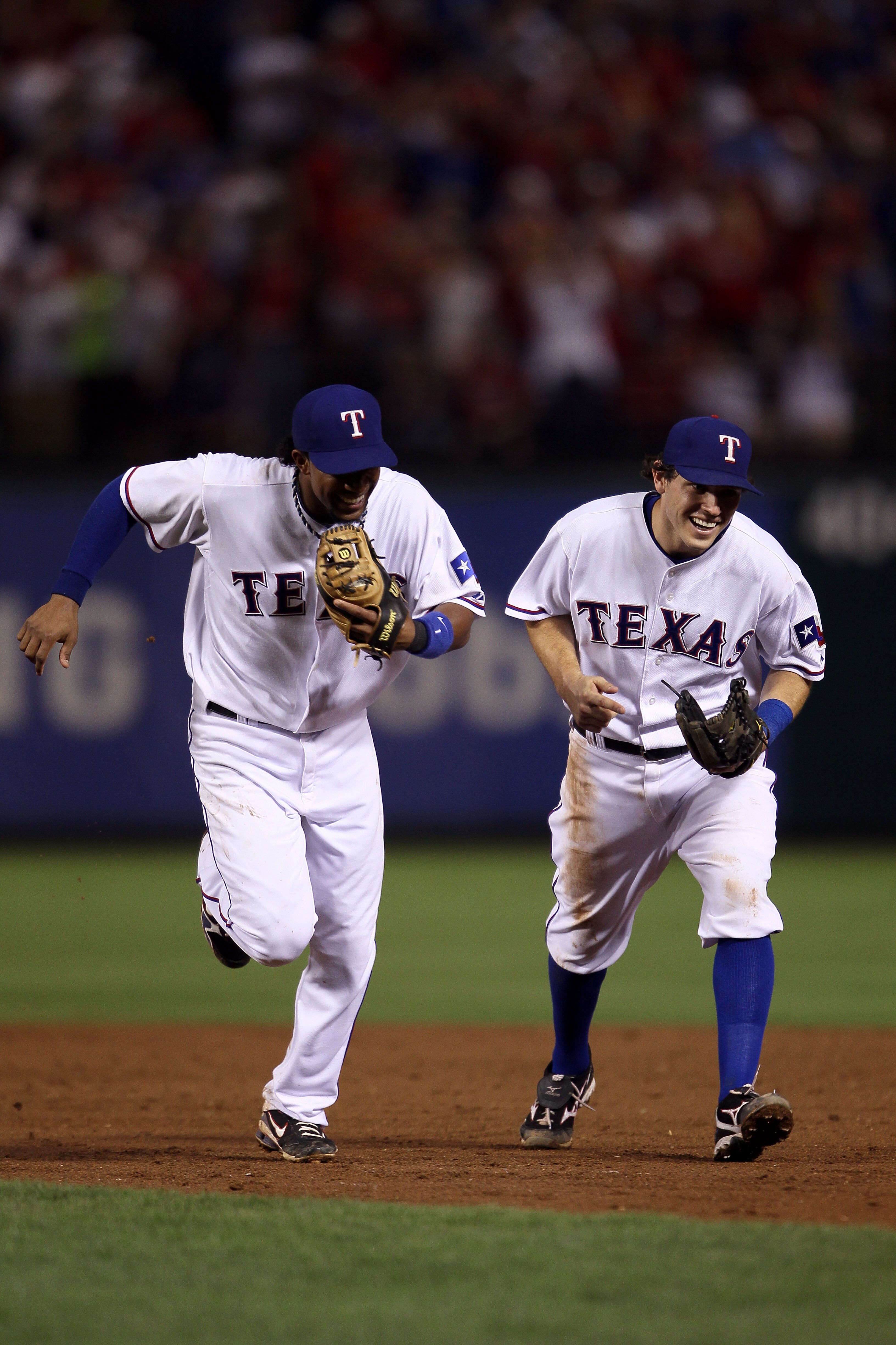 ARLINGTON, TX - OCTOBER 22:  (L-R) Elvis Andrus #1 and Ian Kinsler #5 of the Texas Rangers run off the infield towards the dugout at the end of an inning against  the New York Yankees in Game Six of the ALCS during the 2010 MLB Playoffs at Rangers Ballpar