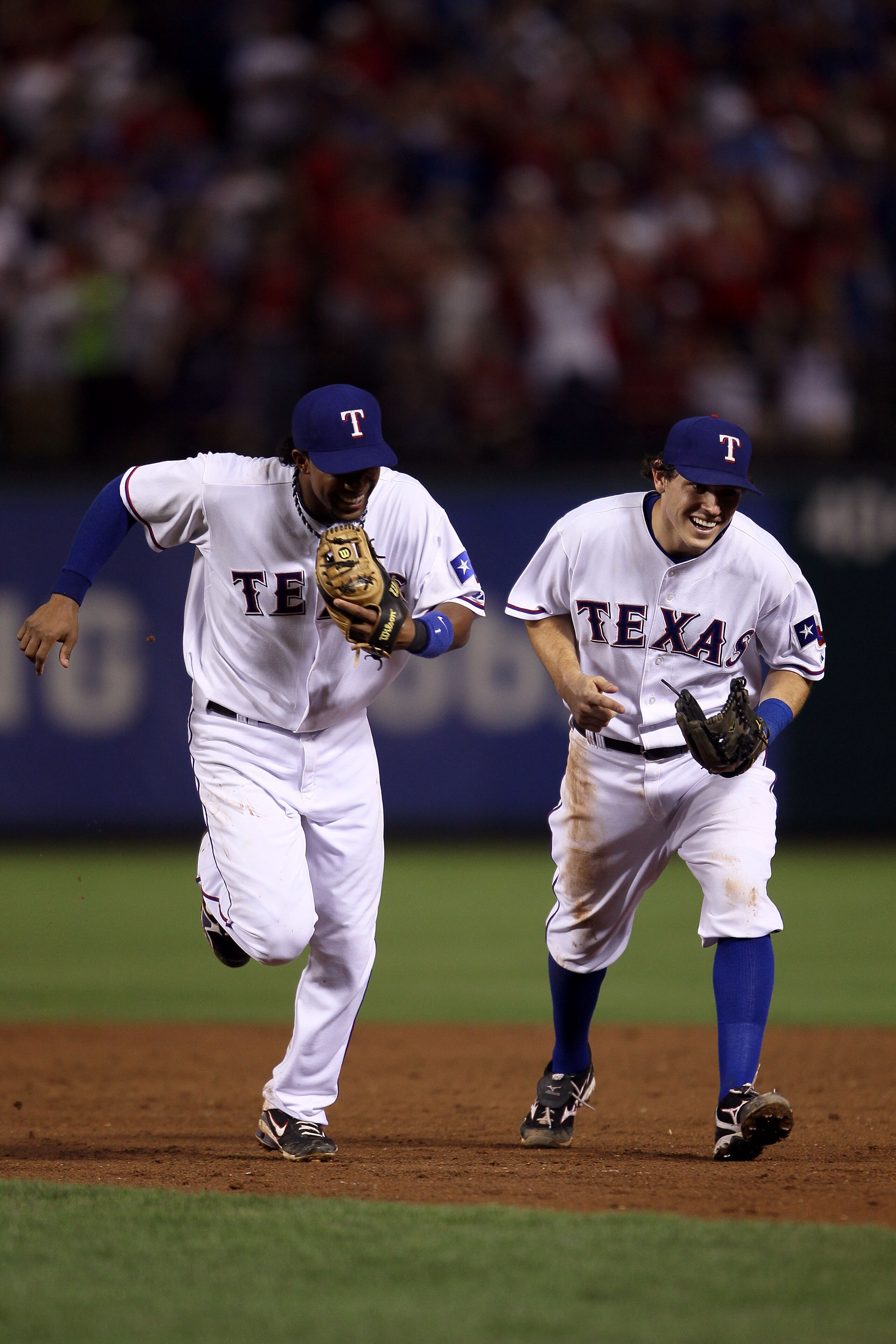 ARLINGTON, TX - OCTOBER 22:  (L-R) Elvis Andrus #1 and Ian Kinsler #5 of the Texas Rangers run off the infield towards the dugout at the end of an inning against  the New York Yankees in Game Six of the ALCS during the 2010 MLB Playoffs at Rangers Ballpar