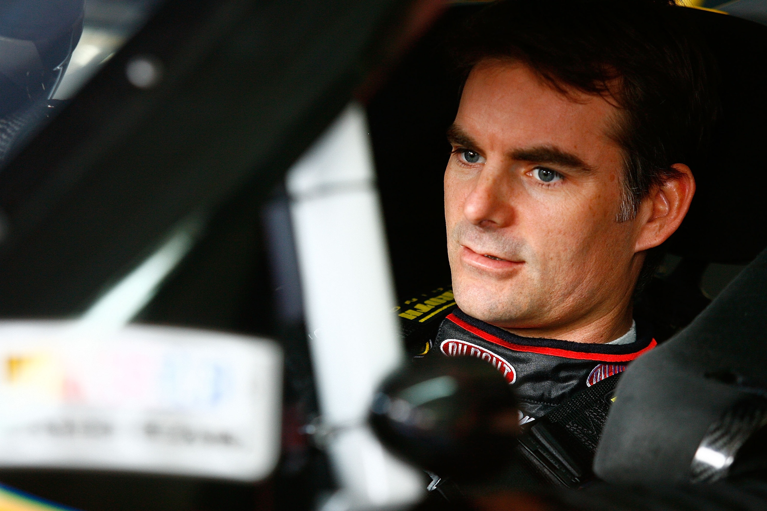 CONCORD, NC - OCTOBER 14:  Jeff Gordon, driver of the #24 DuPont Chevrolet, sits in his car prior to practice for the NASCAR Sprint Cup Series Bank of America 500 at Charlotte Motor Speedway on October 14, 2010 in Concord, North Carolina.  (Photo by Jason