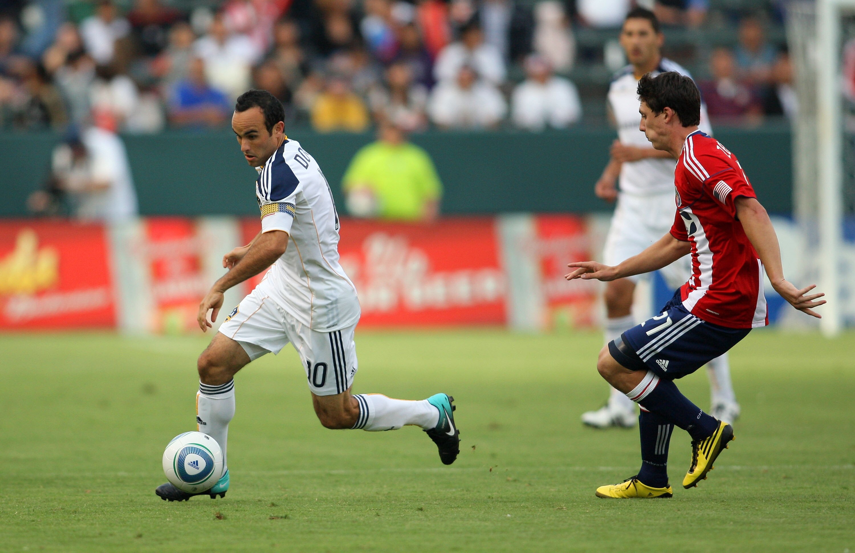 CARSON, CA - OCTOBER 03:  Landon Donovan #10 of the Los Angeles Galaxy paces the ball under pressure from Ben Zemanski #21 of Chivas USA in the first half during the MLS match at The Home Depot Center on October 3, 2010 in Carson, California. The Galaxy d