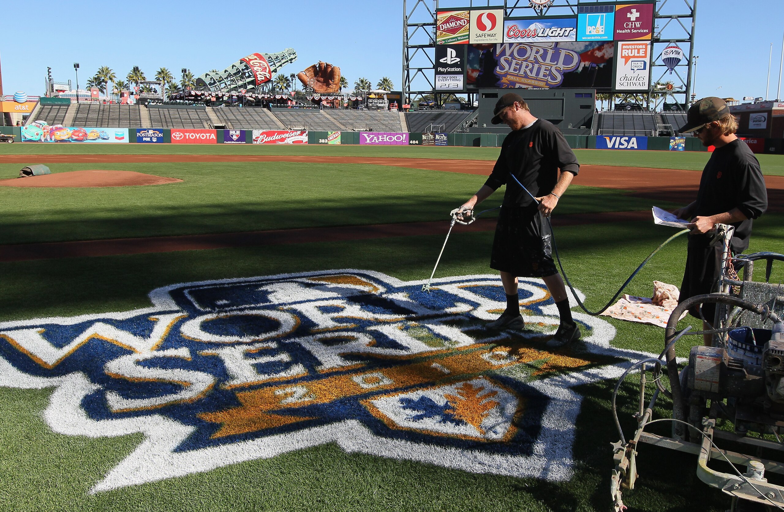 SAN FRANCISCO - OCTOBER 26:  Workers paint the World Series logo onto the field before the start of team workouts at AT&T Park on October 26, 2010 in San Francisco, California.  The San Francisco Giants will face the Texas Rangers in the first game of the