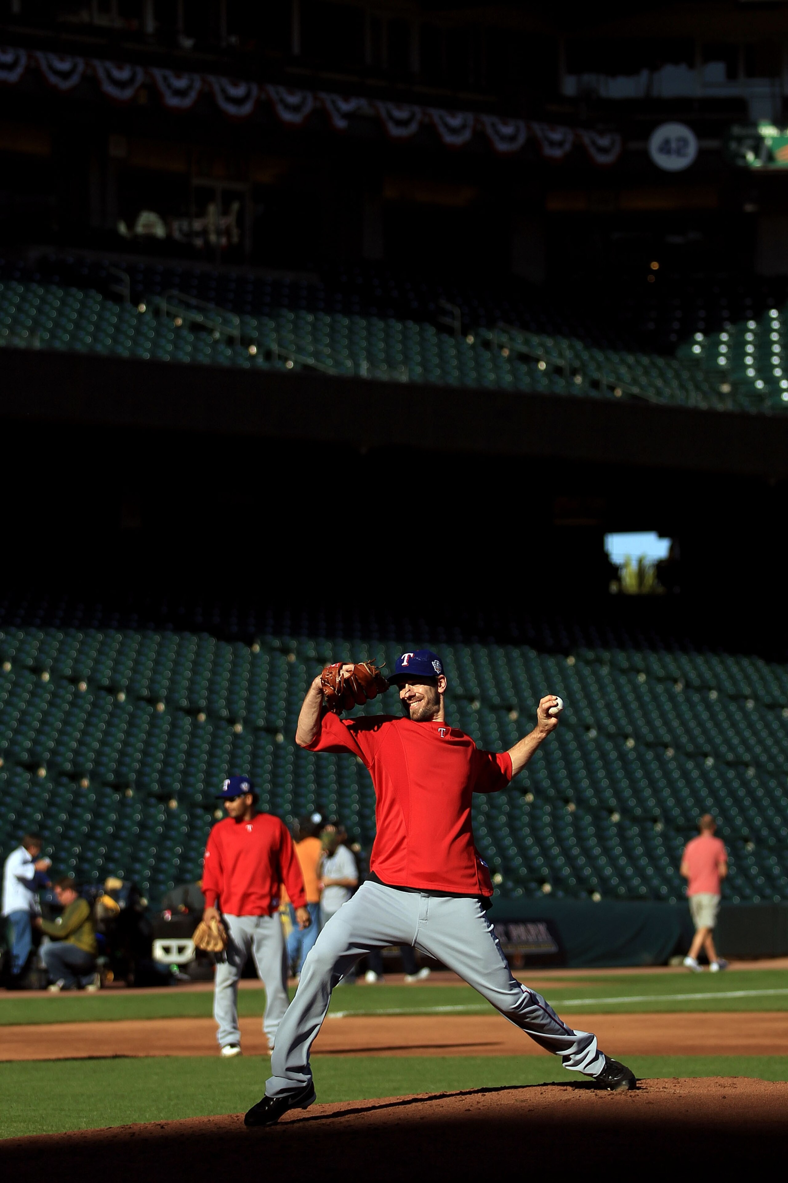 SAN FRANCISCO - OCTOBER 26:  Cliff Lee #33 of the Texas Rangers pitches during a workout session at AT&T Park on October 26, 2010 in San Francisco, California. The Texas Rangers will face off against the San Francisco Giants in Game One of the 2010 MLB Wo