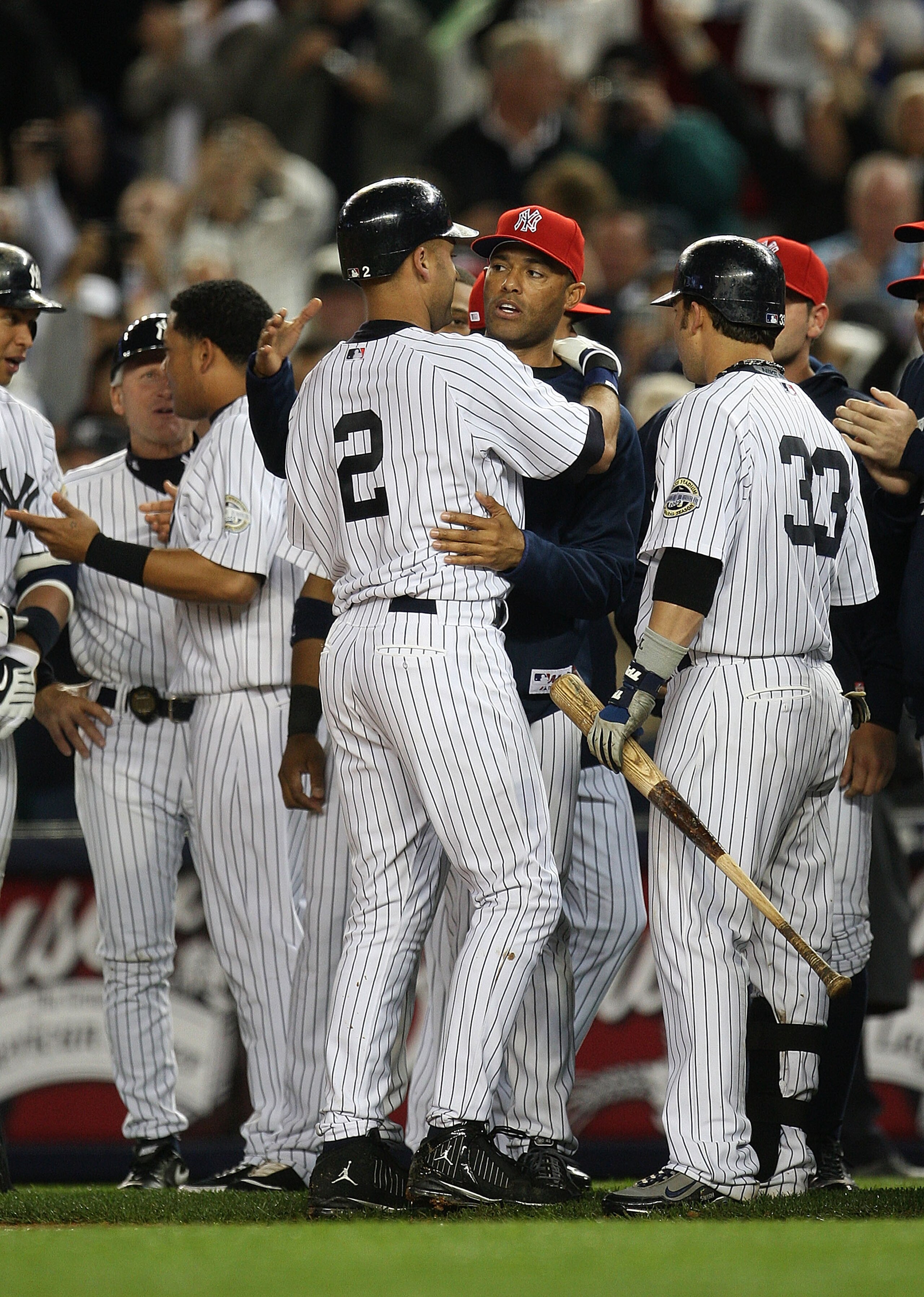 NEW YORK - SEPTEMBER 11:  Derek Jeter #2 of the New York Yankees is congratulated by Mariano Rivera  after hitting a single to right field in the third inning during a game against the Baltimore Orioles at Yankee Stadium on September 11, 2009 in the Bronx