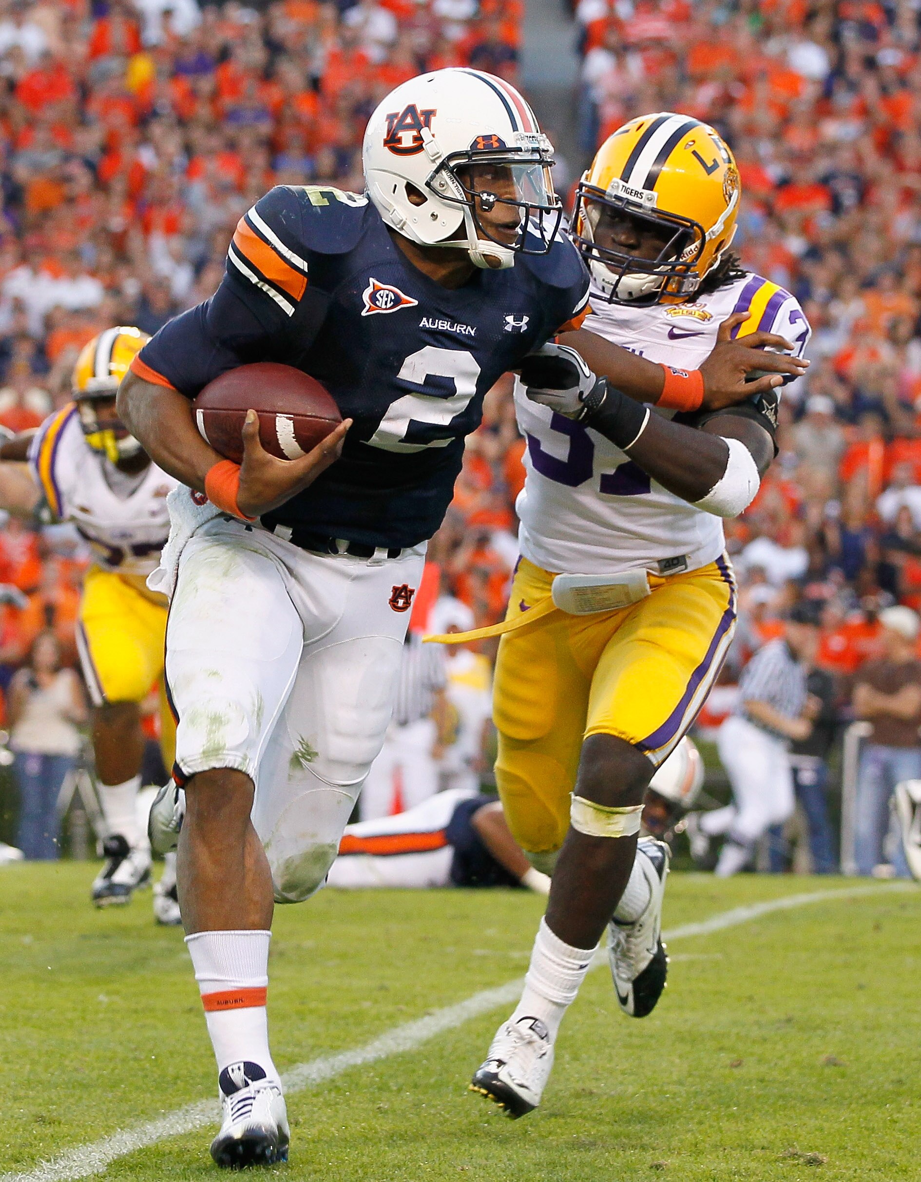 AUBURN, AL - OCTOBER 23:  Quarterback Cameron Newton #2 of the Auburn Tigers stiff arms Karnell Hatcher #37 of the LSU Tigers at Jordan-Hare Stadium on October 23, 2010 in Auburn, Alabama.  (Photo by Kevin C. Cox/Getty Images)