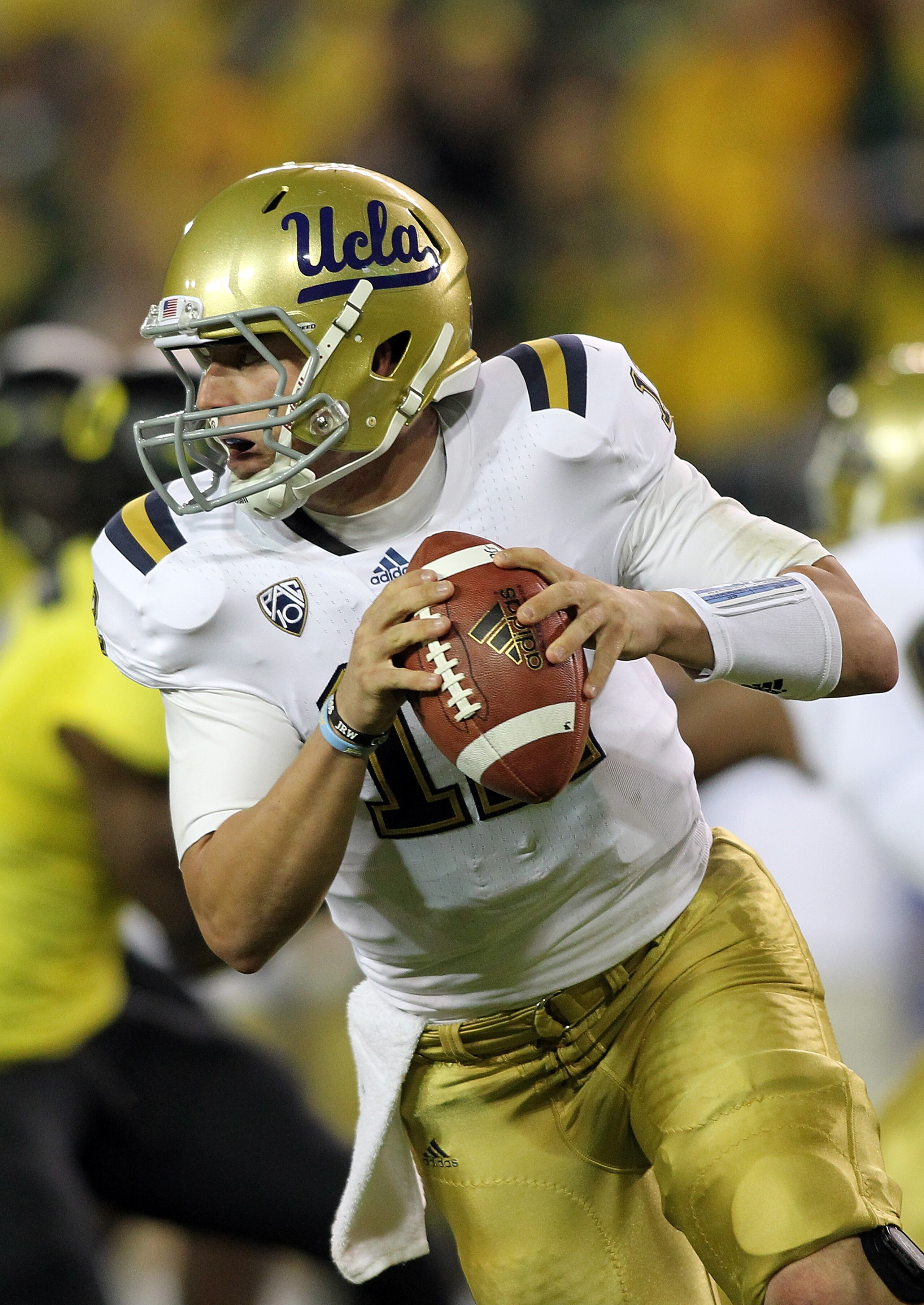 EUGENE, OR - OCTOBER 21:  Richard Brehaut #12 of the UCLA Bruins  scrambles out of the pocket against the Oregon Ducks on October 21, 2010 at the Autzen Stadium in Eugene, Oregon.  (Photo by Jonathan Ferrey/Getty Images)
