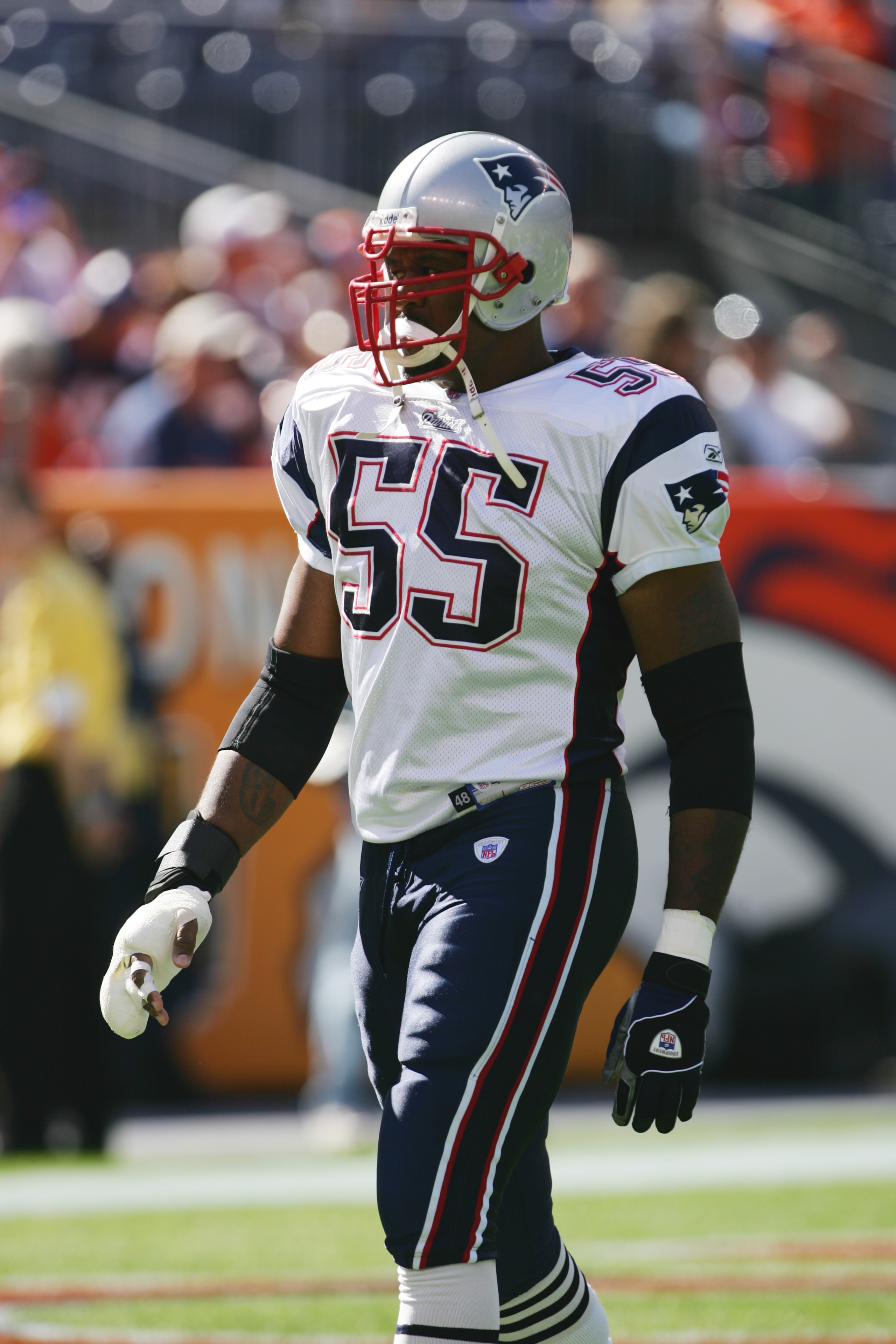 DENVER - OCTOBER 16:  Linebacker Willie McGinest #55 of the New England Patriots looks on during warmups against the Denver Broncos at INVESCO Field at Mile High on October 16, 2005 in Denver, Colorado. The Broncos defeated the Pats 28-20. (Photo by Doug