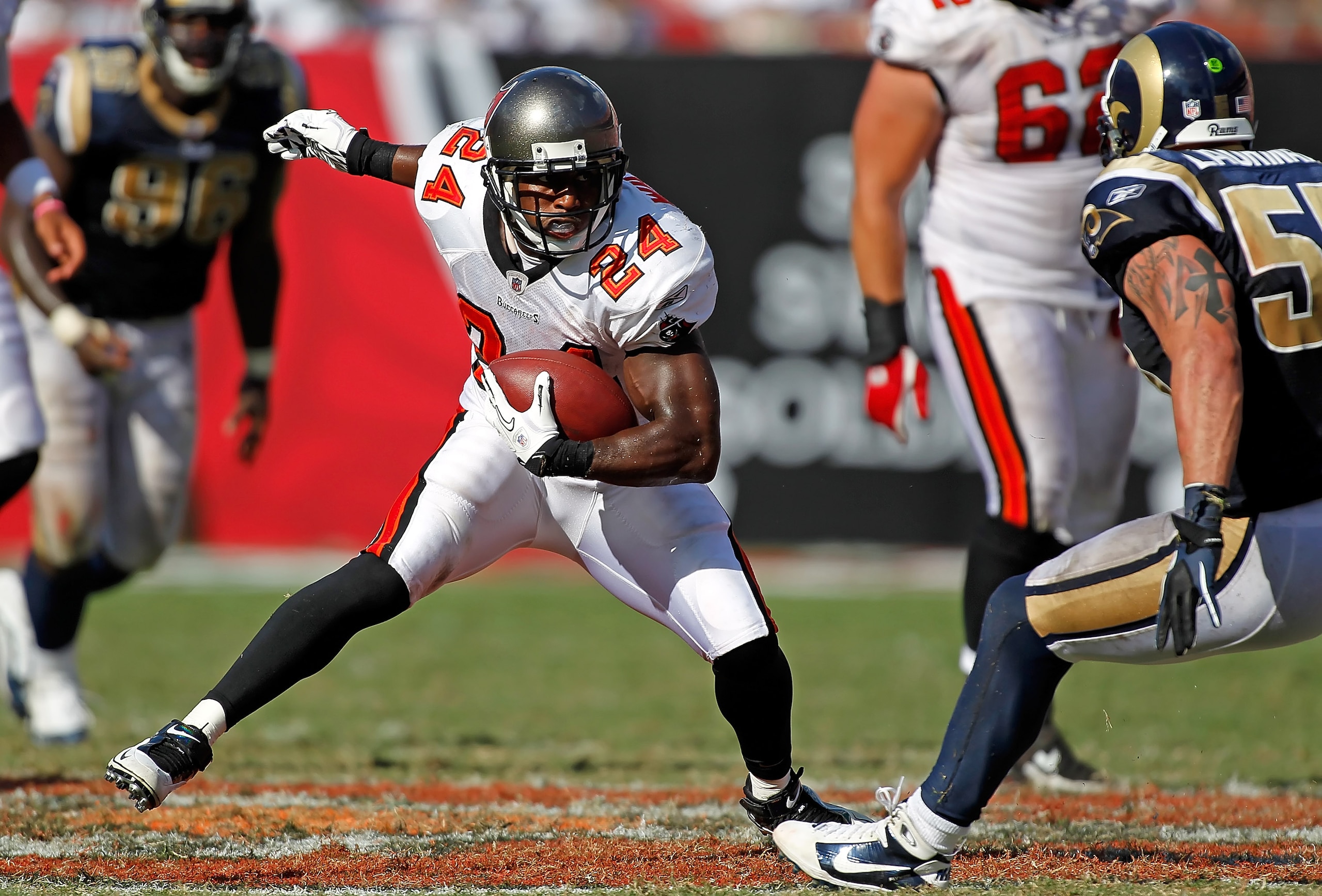 TAMPA, FL - OCTOBER 24:  Running back Carnell Williams #24 of the Tampa Bay Buccaneers puts a move on linebacker James Laurinaitis #55 of the St. Louis Rams during the game at Raymond James Stadium on October 24, 2010 in Tampa, Florida.  (Photo by J. Meri